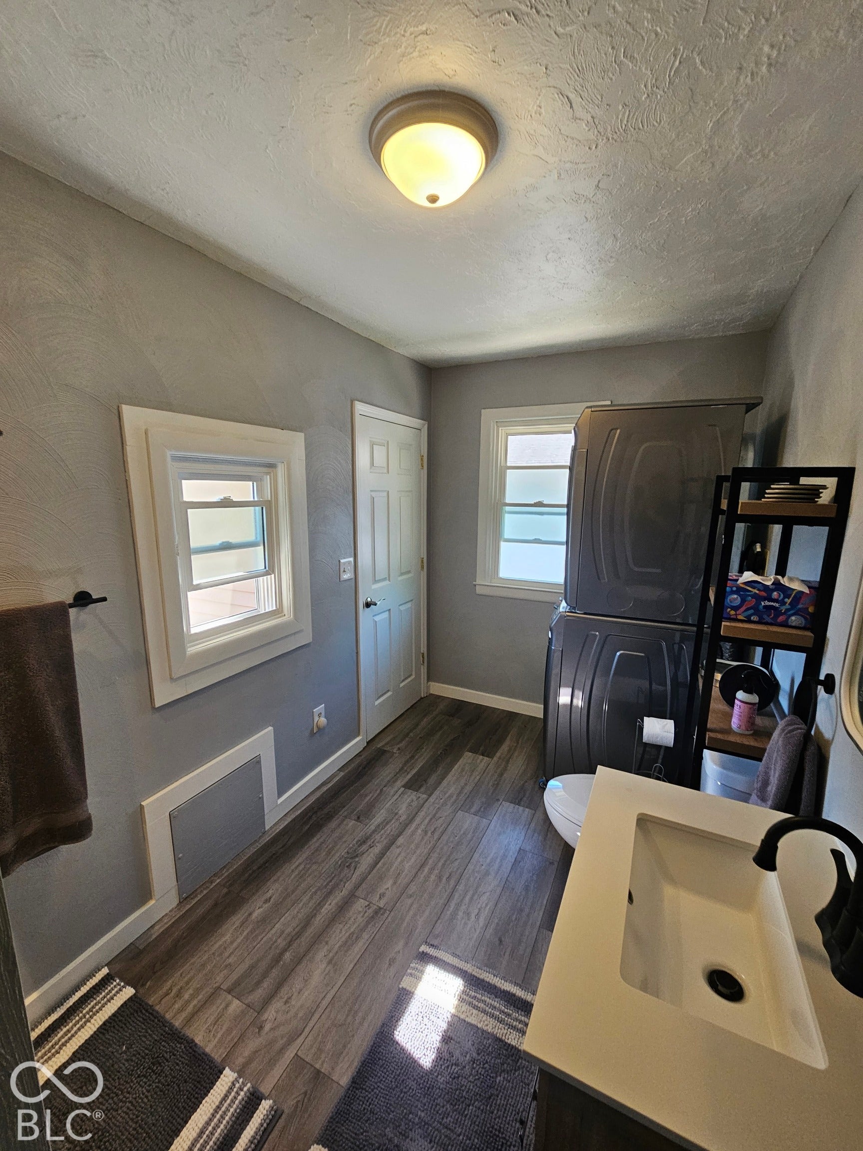 917 W 8th Street, Anderson, IN 46016 Vanity with integrated sink, matte black faucet, and wood-finish flooring