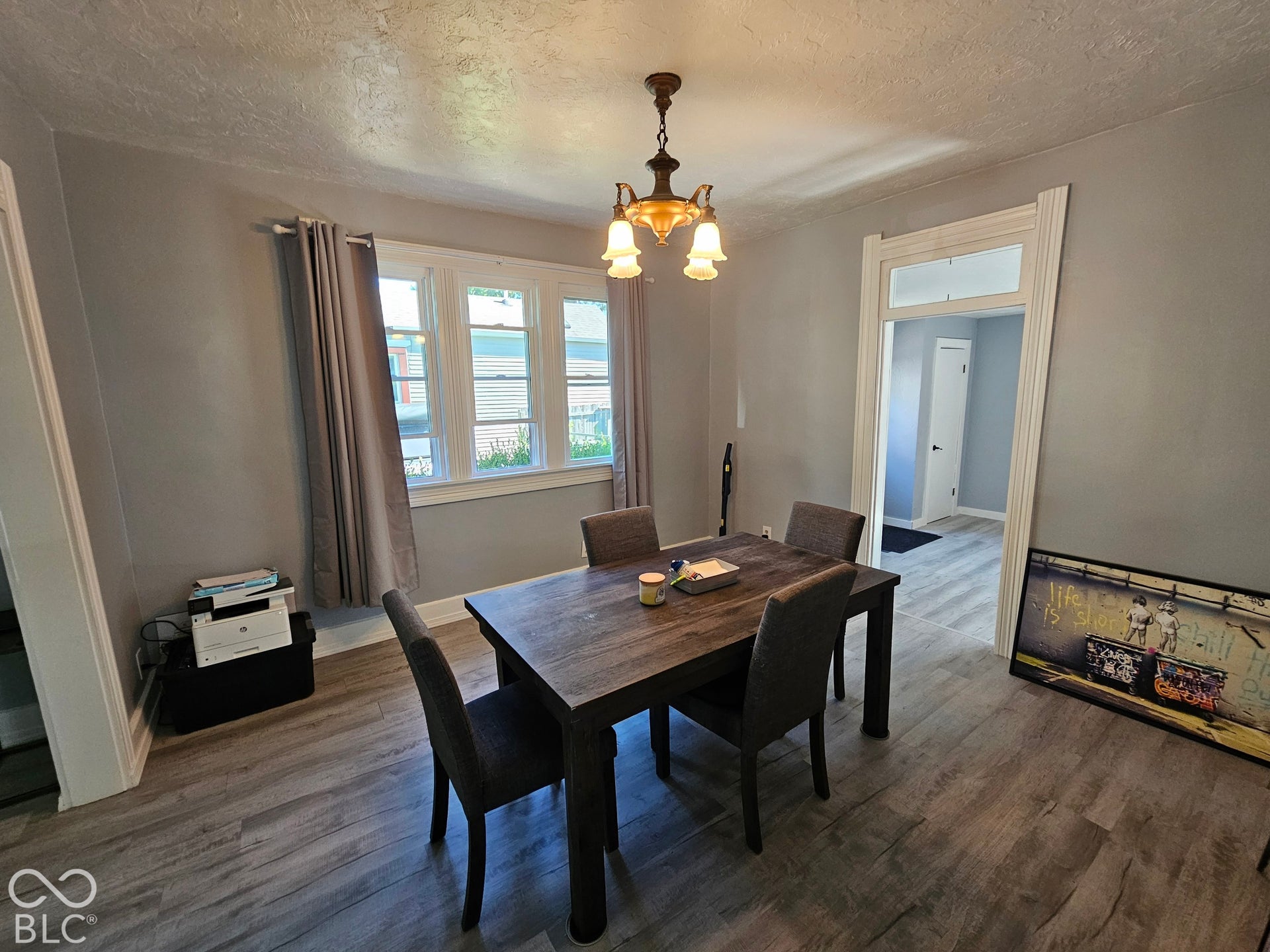 917 W 8th Street, Anderson, IN 46016 Wood-finish flooring throughout, light gray wall paint, and a ceiling-mounted light fixture with frosted glass shades
