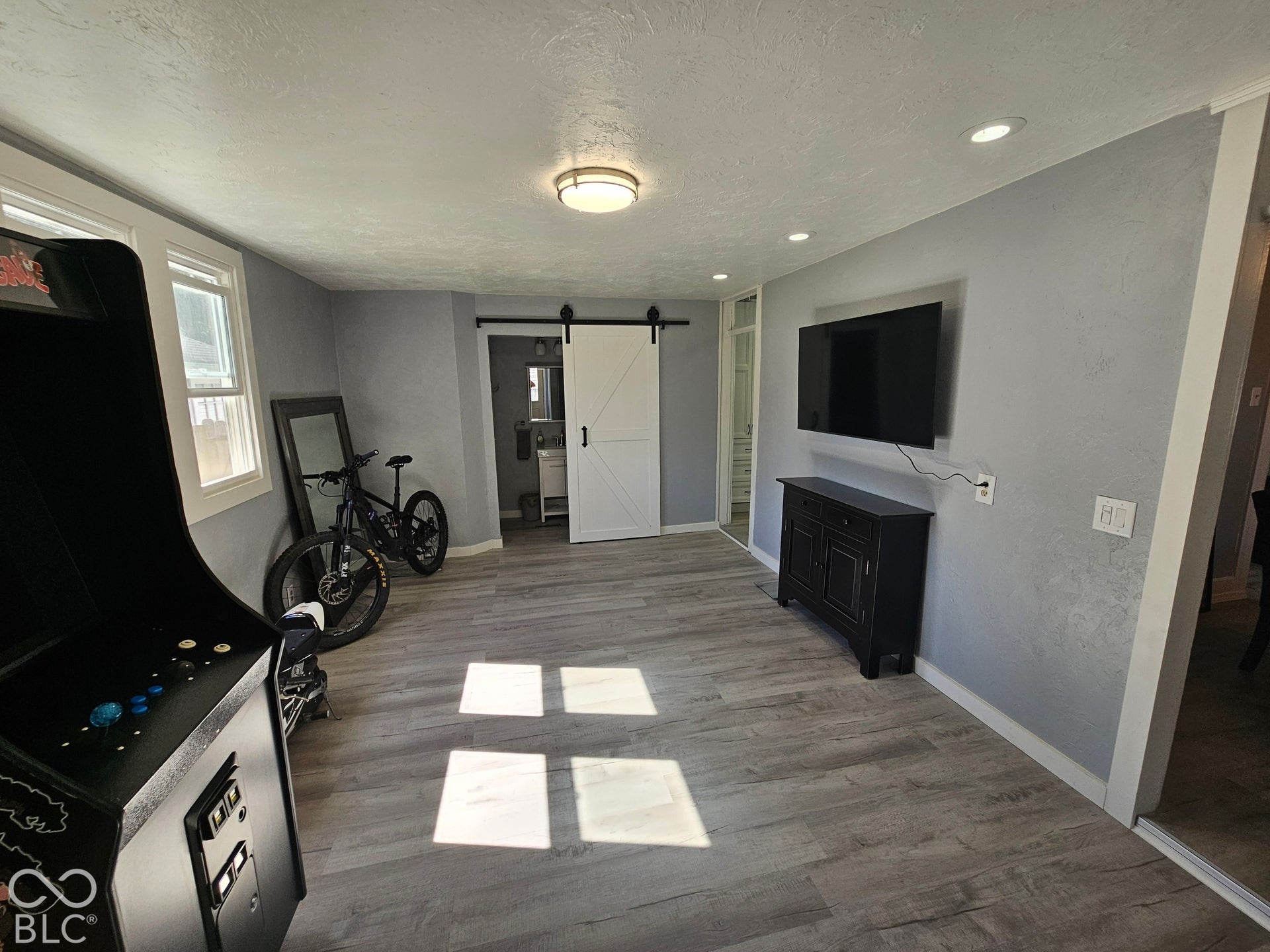 917 W 8th Street, Anderson, IN 46016 Wood-finish flooring throughout, recessed lighting, and a white barn door