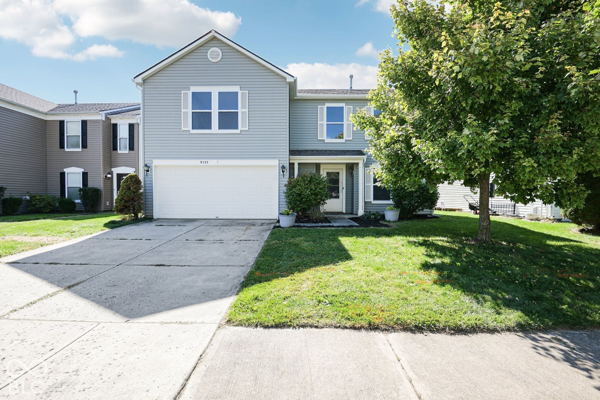 Light blue siding exterior with white window shutters