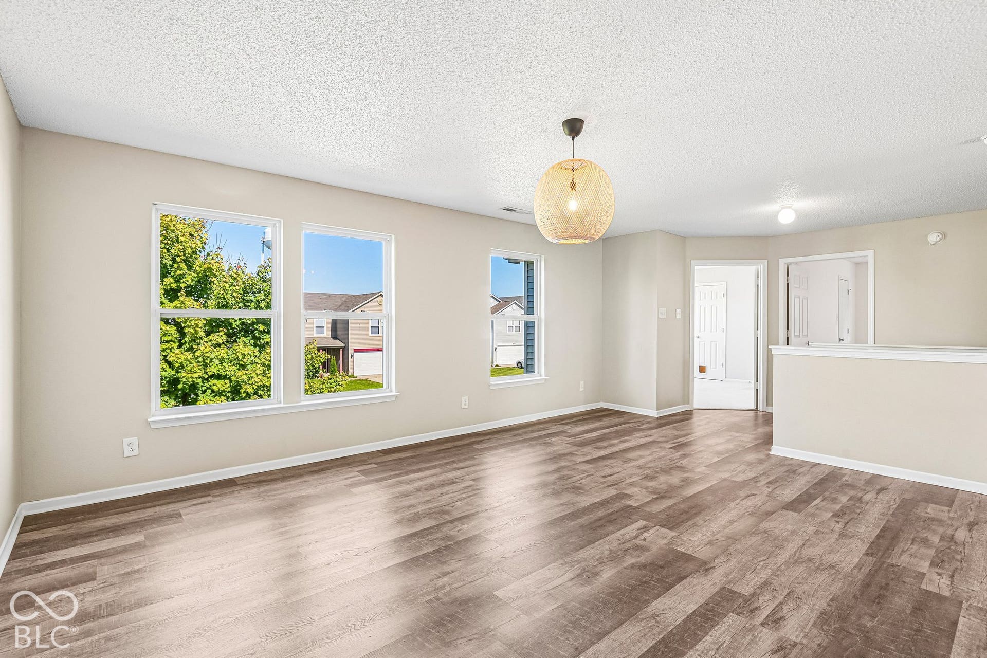 Wood-finish flooring with neutral wall paint and white trim