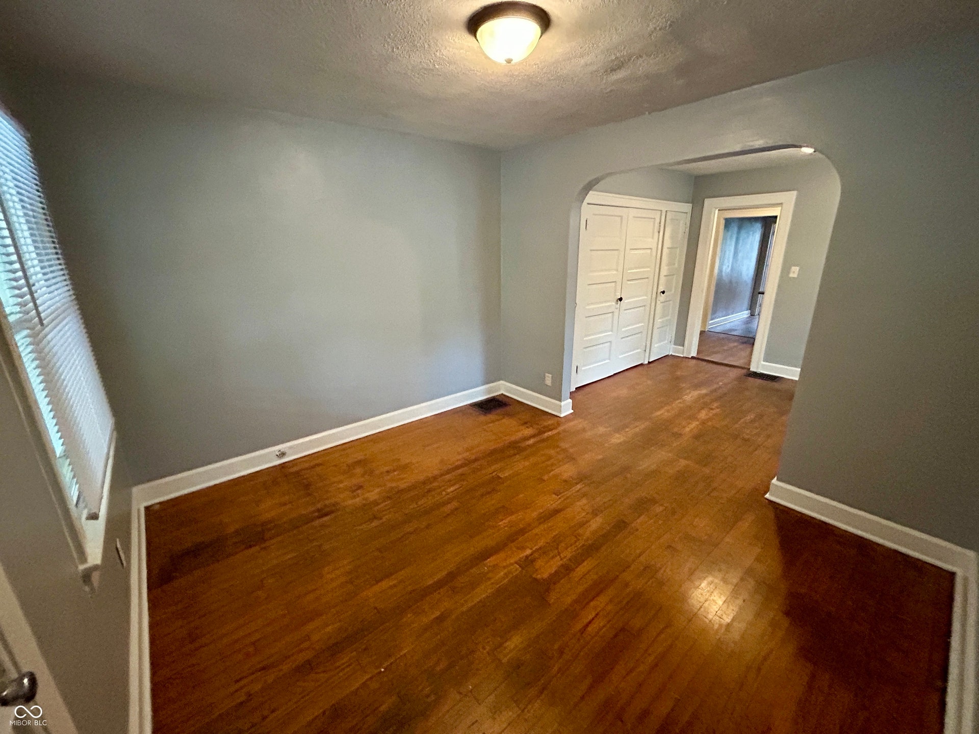 Hardwood flooring extending throughout the room