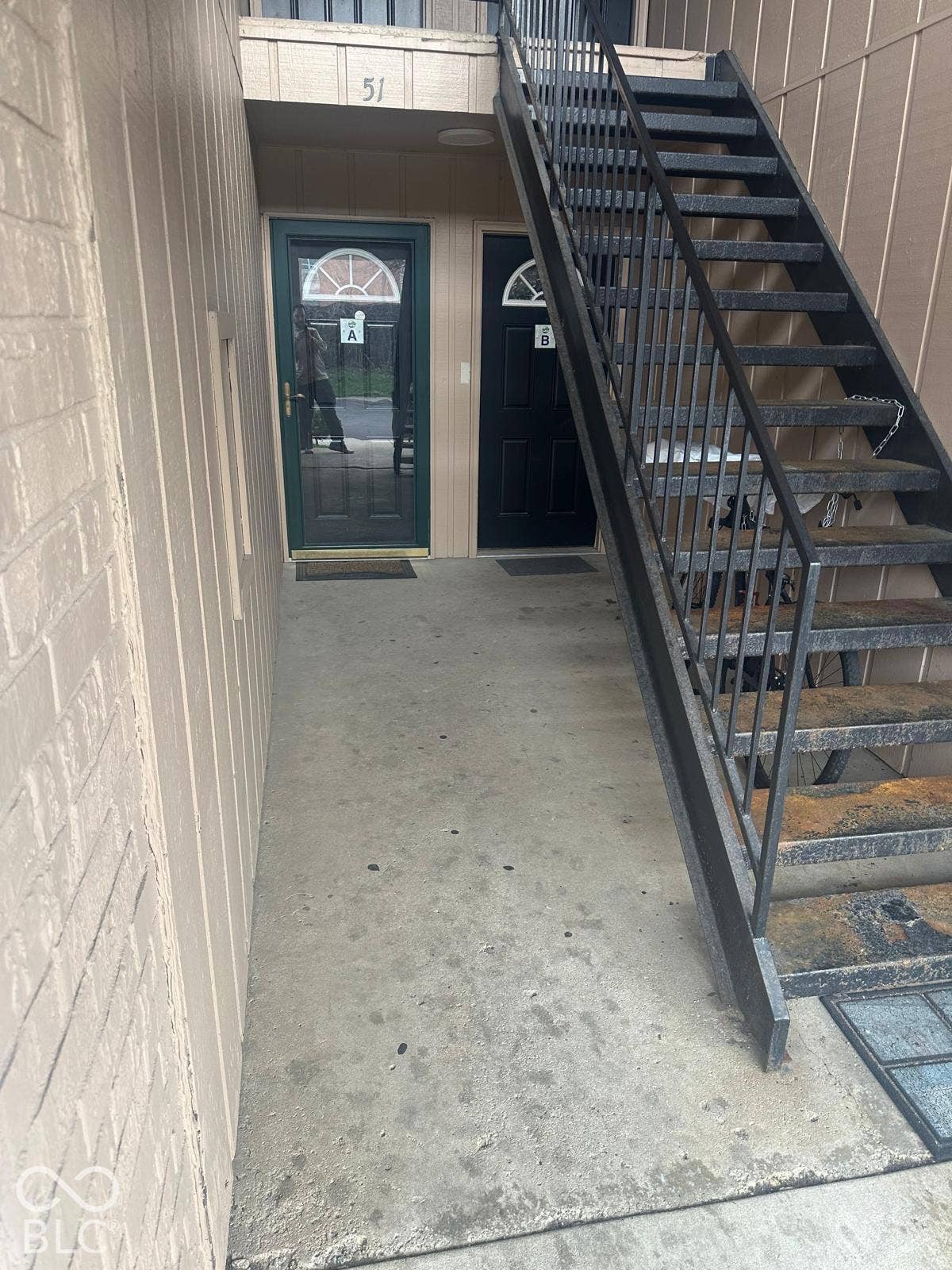 Two entry doors with transom windows