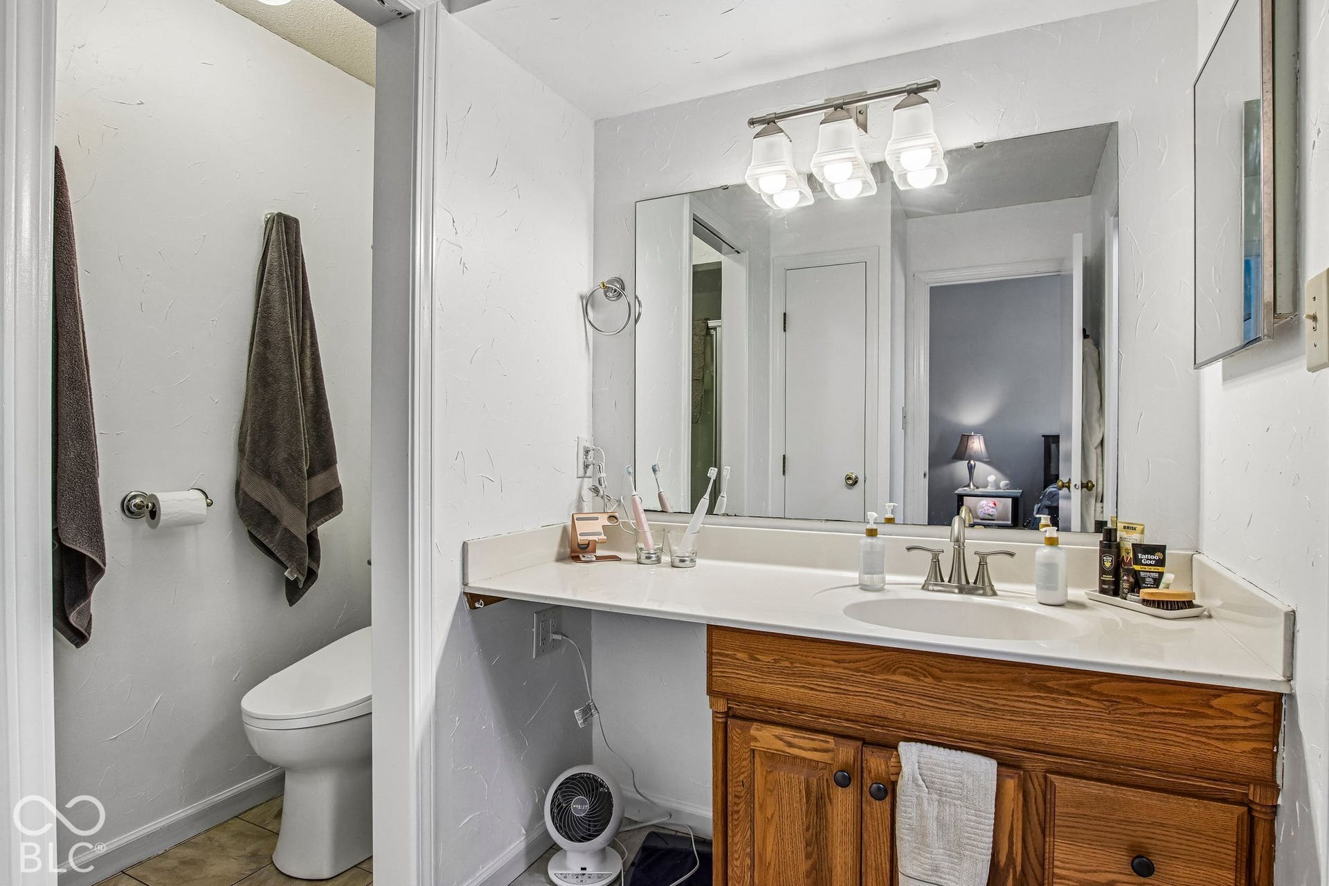 White vanity countertop with an integrated sink and brushed nickel faucet