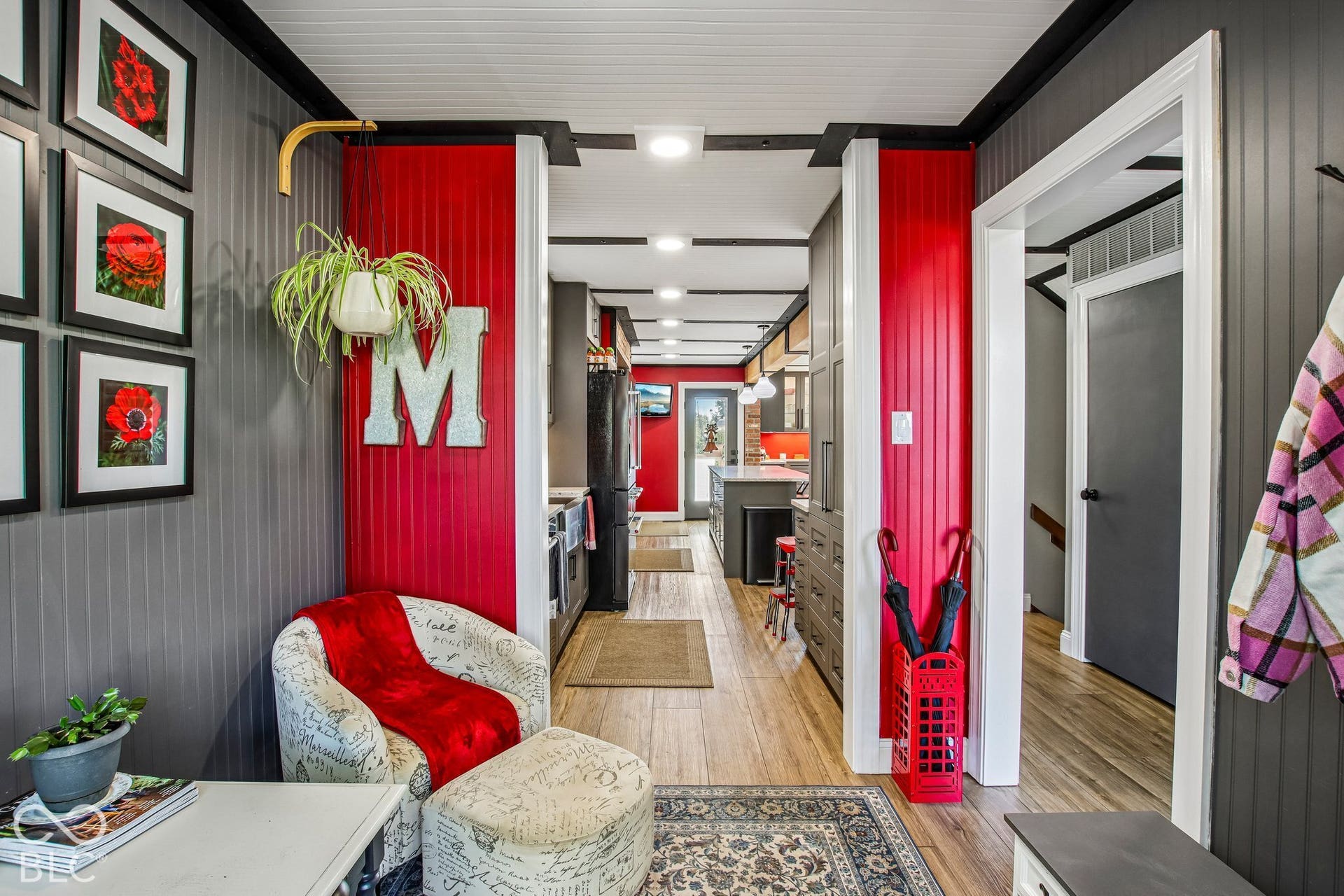 Hardwood-finish flooring, beadboard wall paneling, recessed lighting, and a kitchen featuring built-in cabinetry