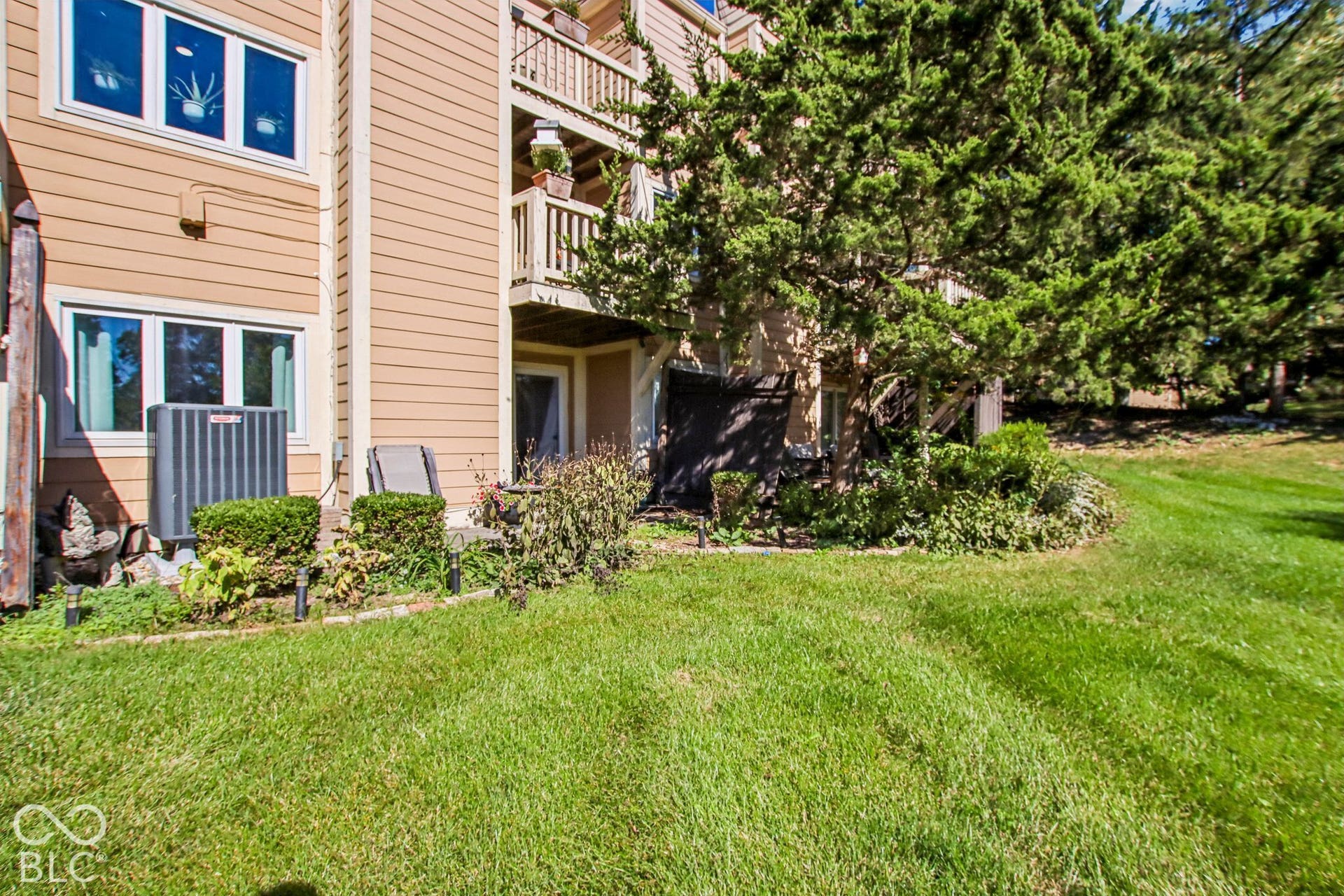 Manicured lawn with mature trees and established landscaping