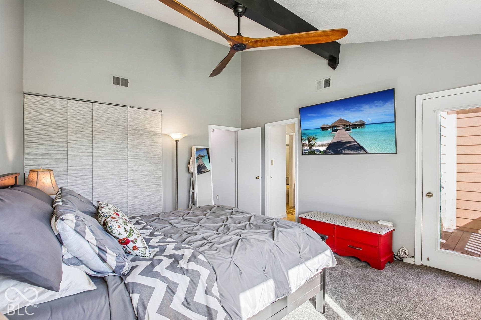 Vaulted ceiling with exposed beam and ceiling fan