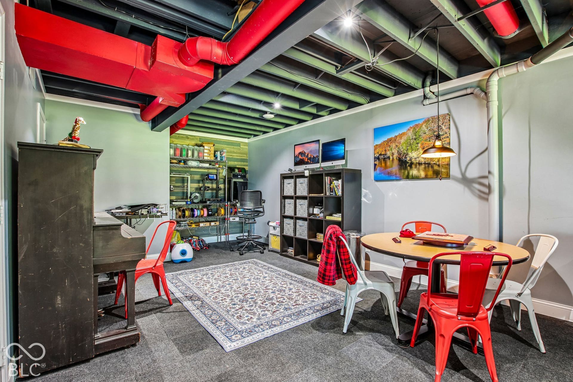 Exposed ceiling beams with red painted ductwork and recessed lighting