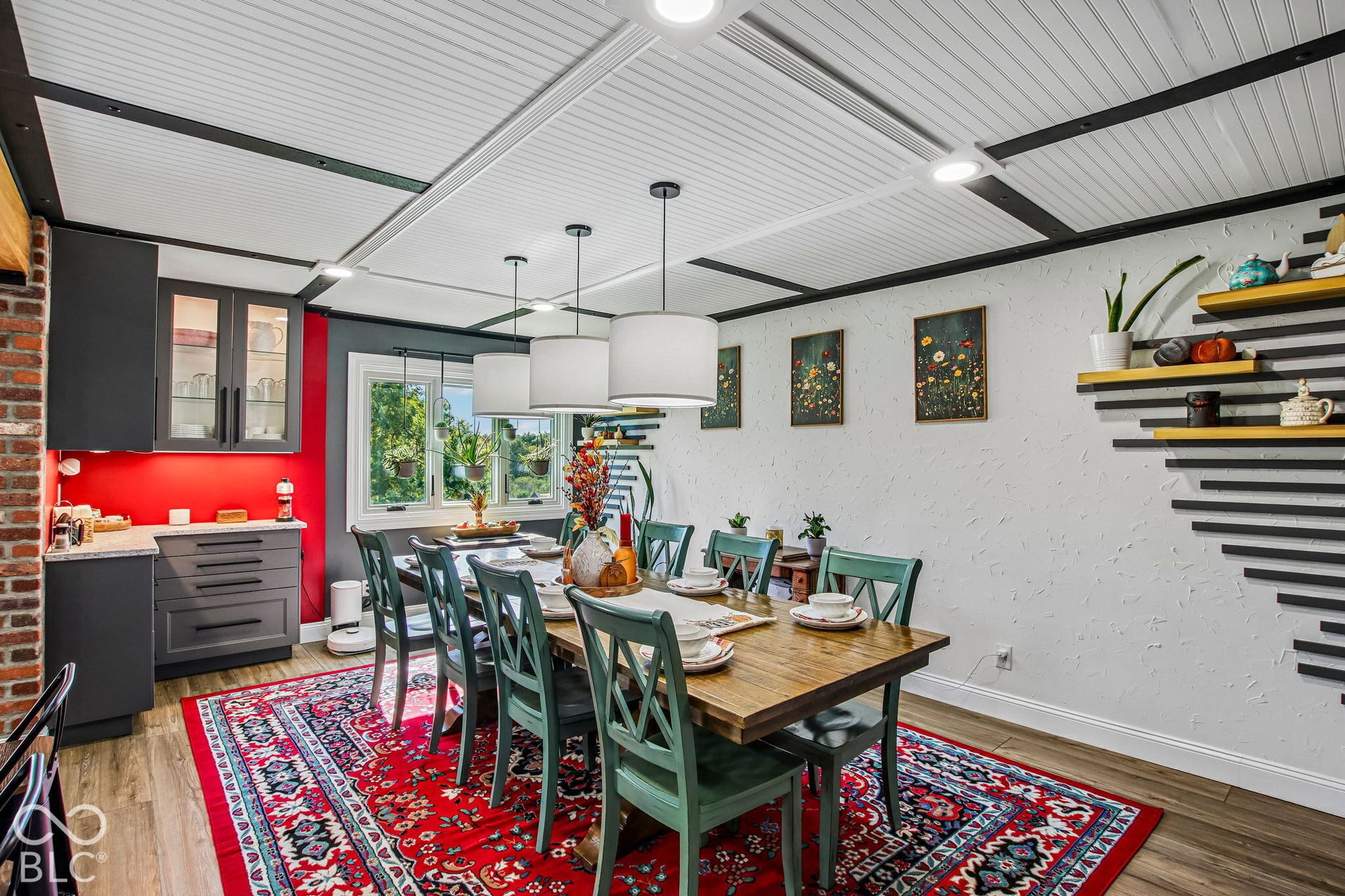 Built-in cabinetry with glass-front uppers, wood-finish flooring, and a decorative paneled ceiling with integrated lighting
