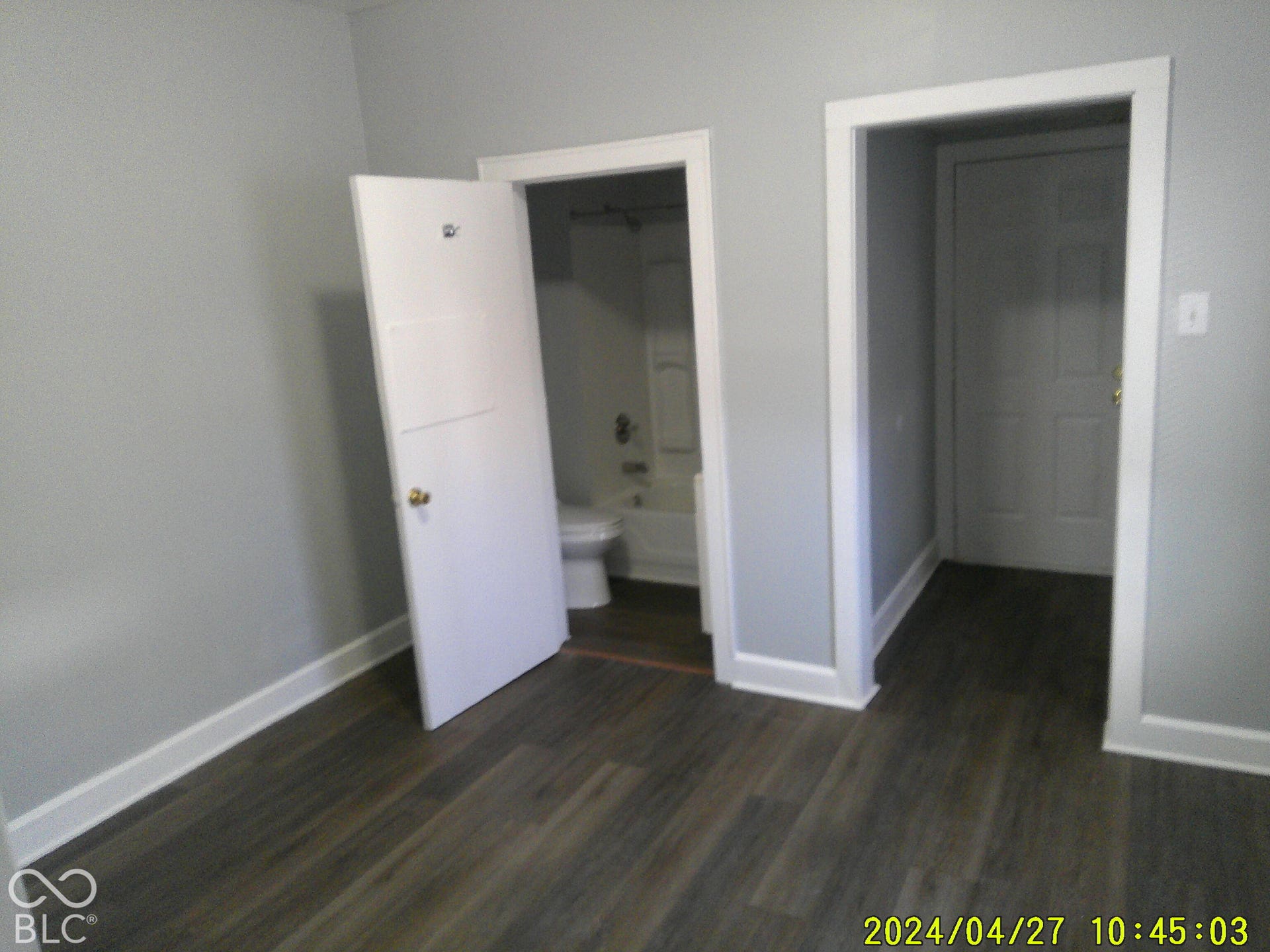 Wood-finish flooring with crisp white trim throughout