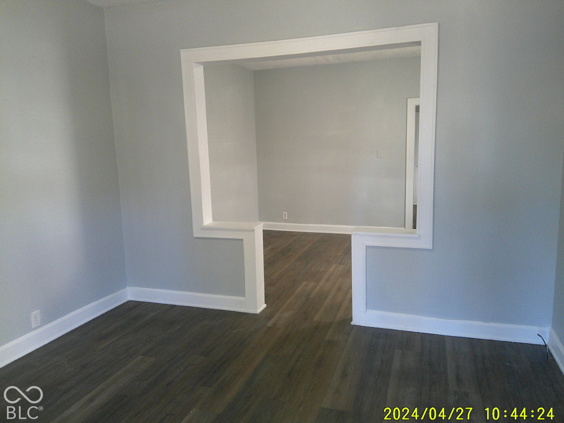 Wood-finish flooring throughout, light gray wall paint, and white trim accents