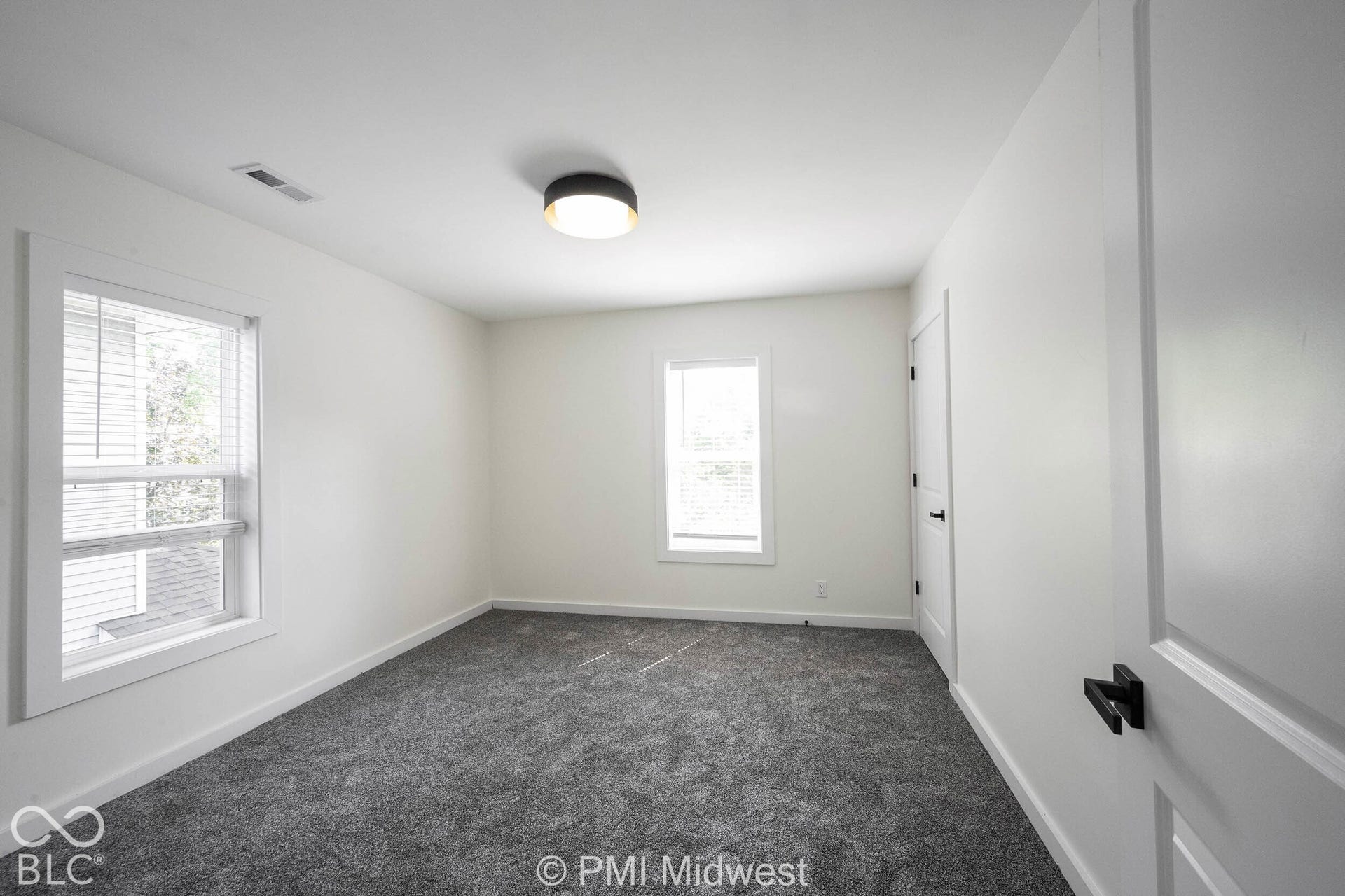 White walls complement gray carpet flooring