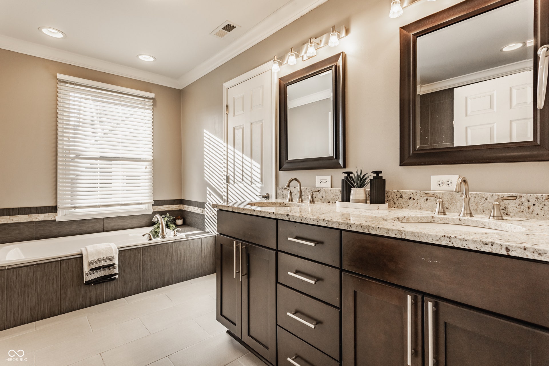 Primary bath includes soaking tub, large tiled shower and walk in closet.