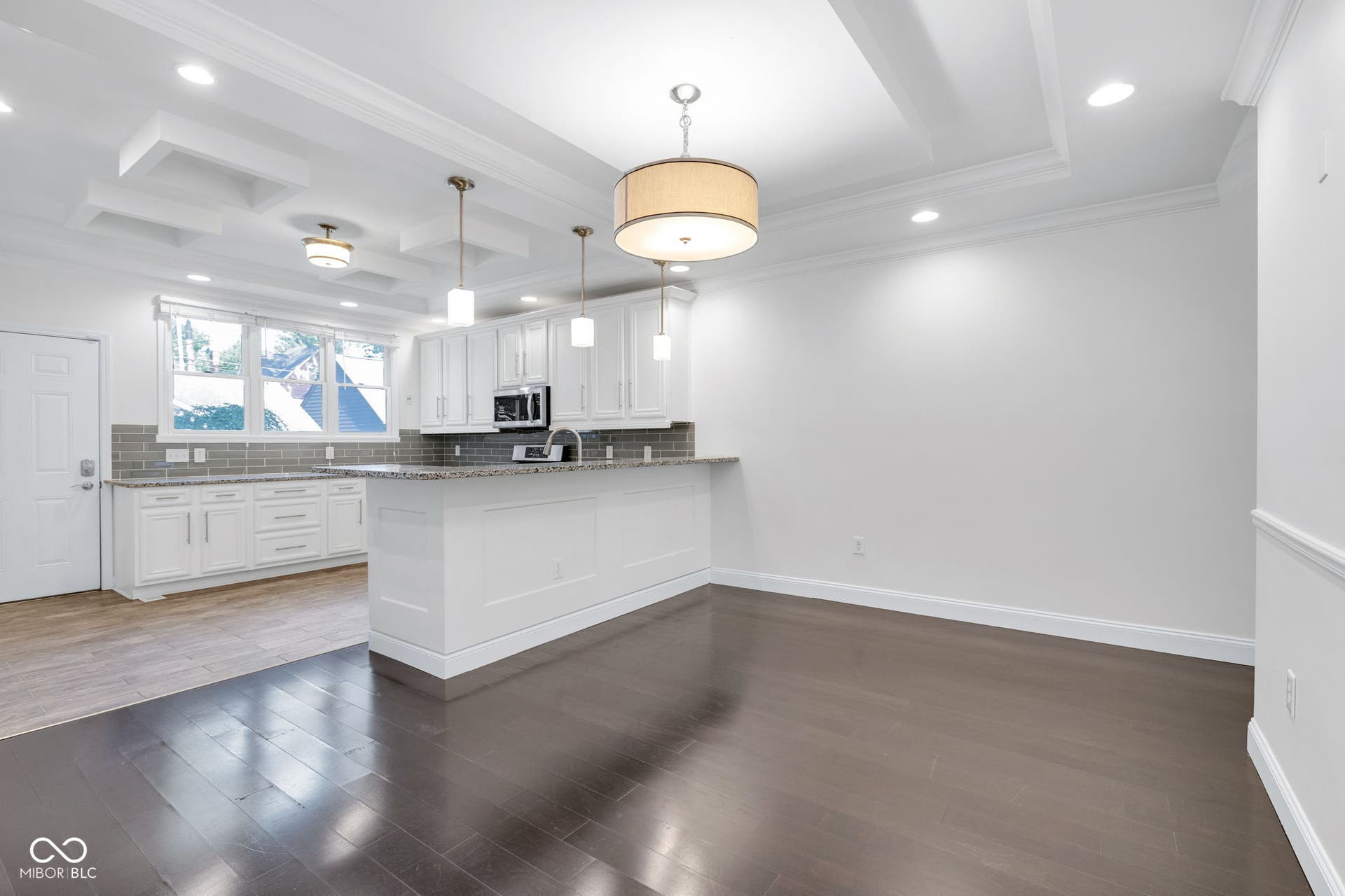 kitchen featuring ornamental molding, recessed lighting, white cabinetry, tasteful backsplash, and dark wood-type flooring