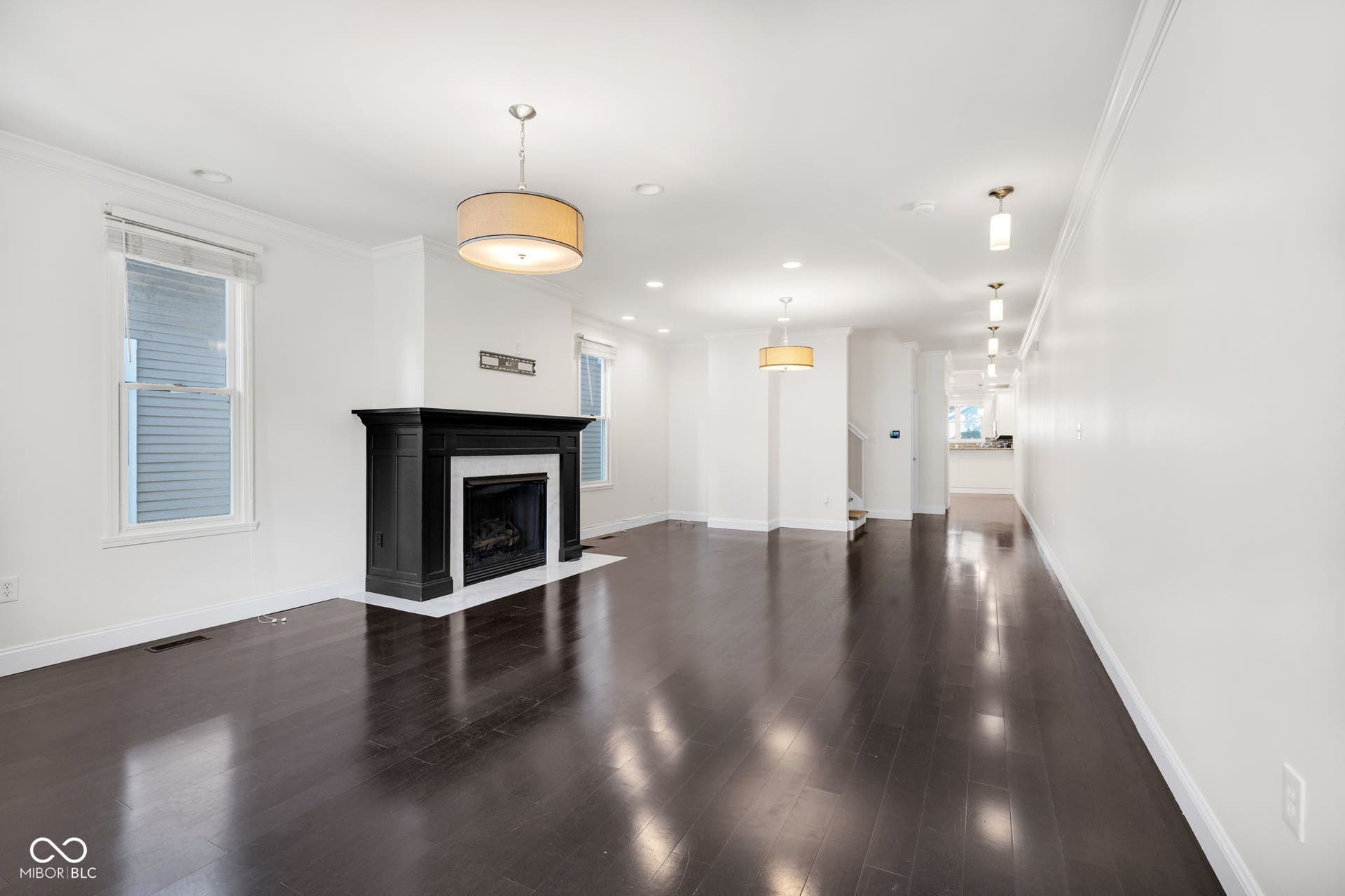 Freshly painted (7/2025) living room featuring crown molding, wood finished floors, a fireplace with flush hearth, and recessed lighting