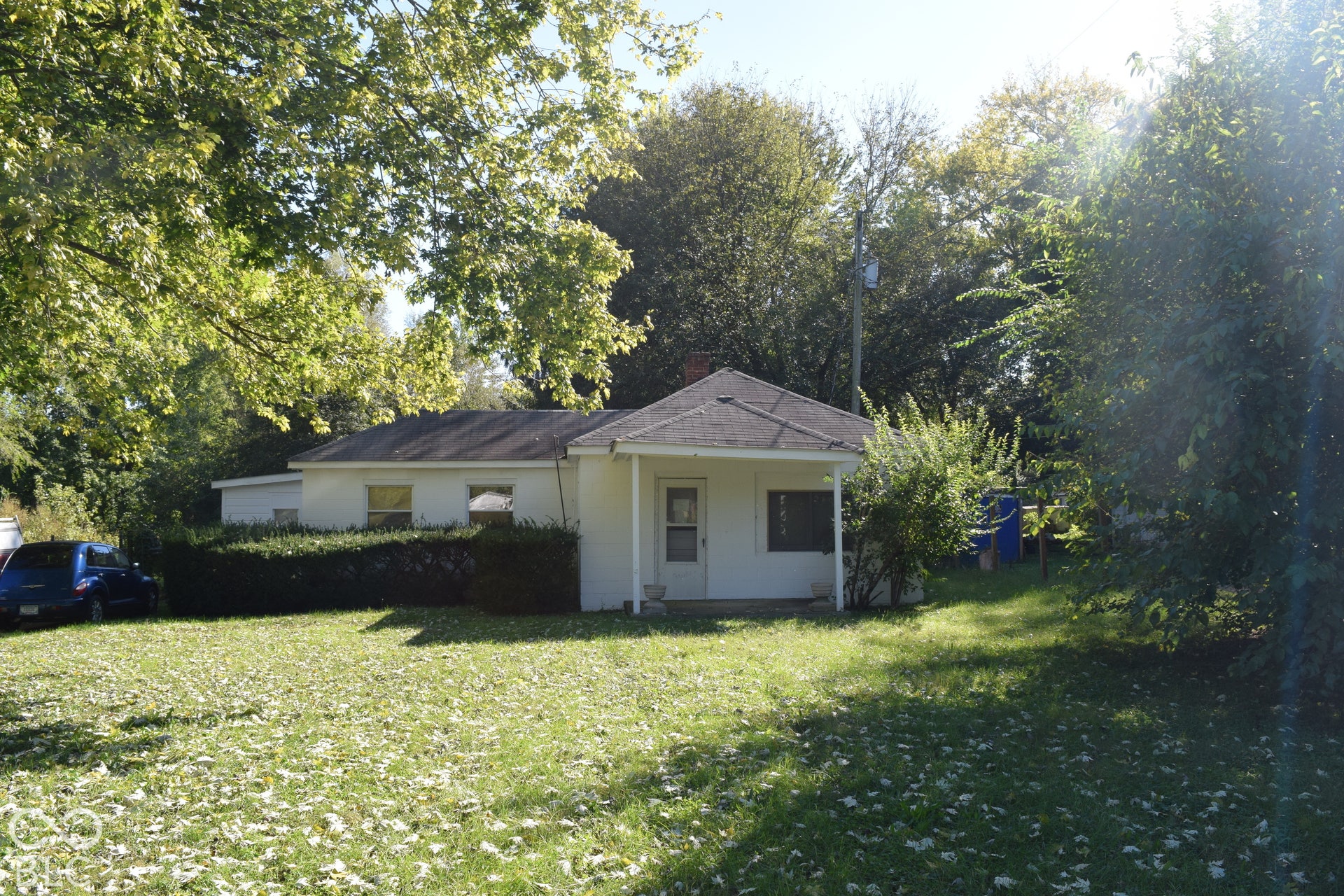 White exterior with a covered front entry and a dark-toned roof