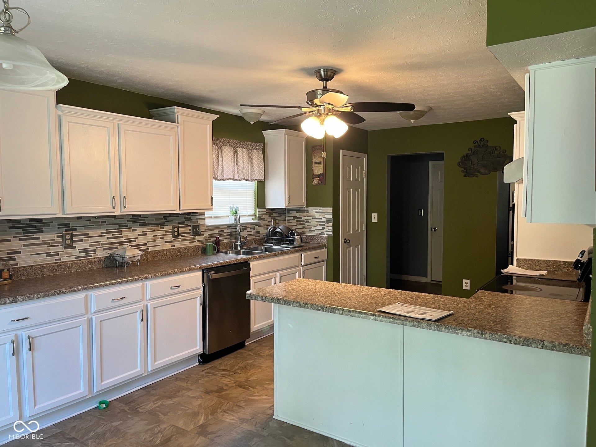 Kitchen featuring white cabinetry, stone-finish countertops, mosaic tile backsplash, and stainless steel appliances