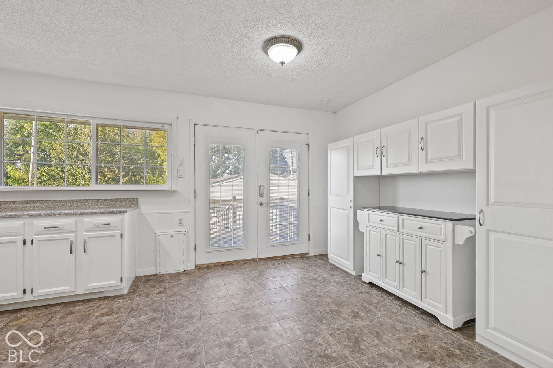 White cabinetry throughout with a built-in hutch featuring a dark countertop