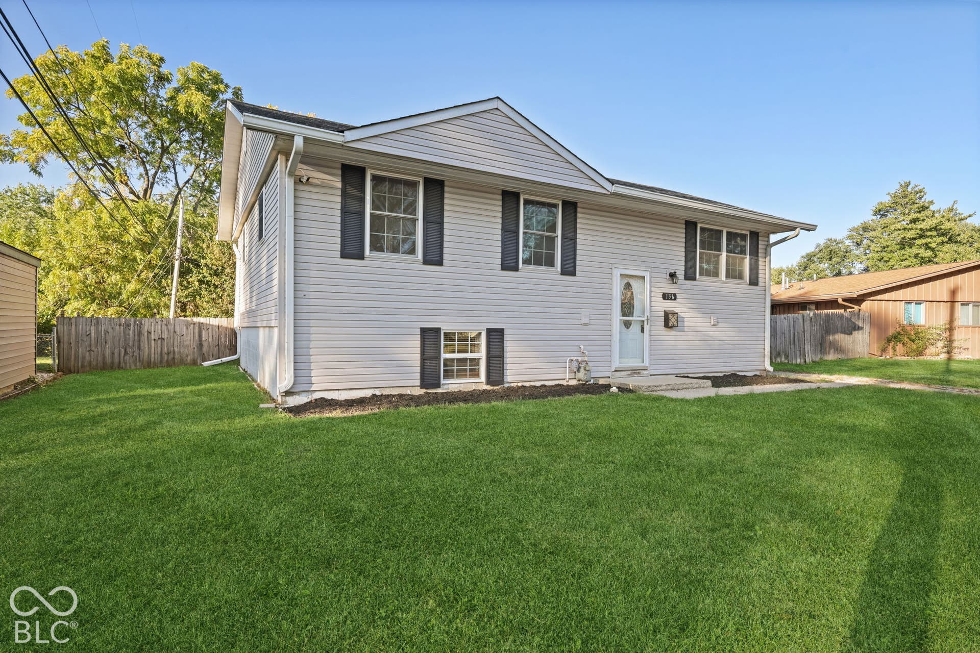 Virtually Altered - Light gray siding exterior with black window shutters