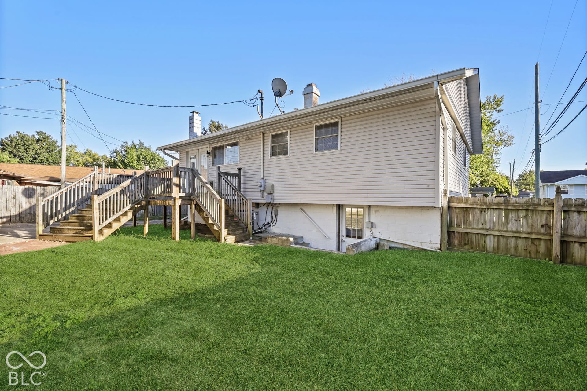 Virtually Altered - Expansive green lawn with a wooden privacy fence