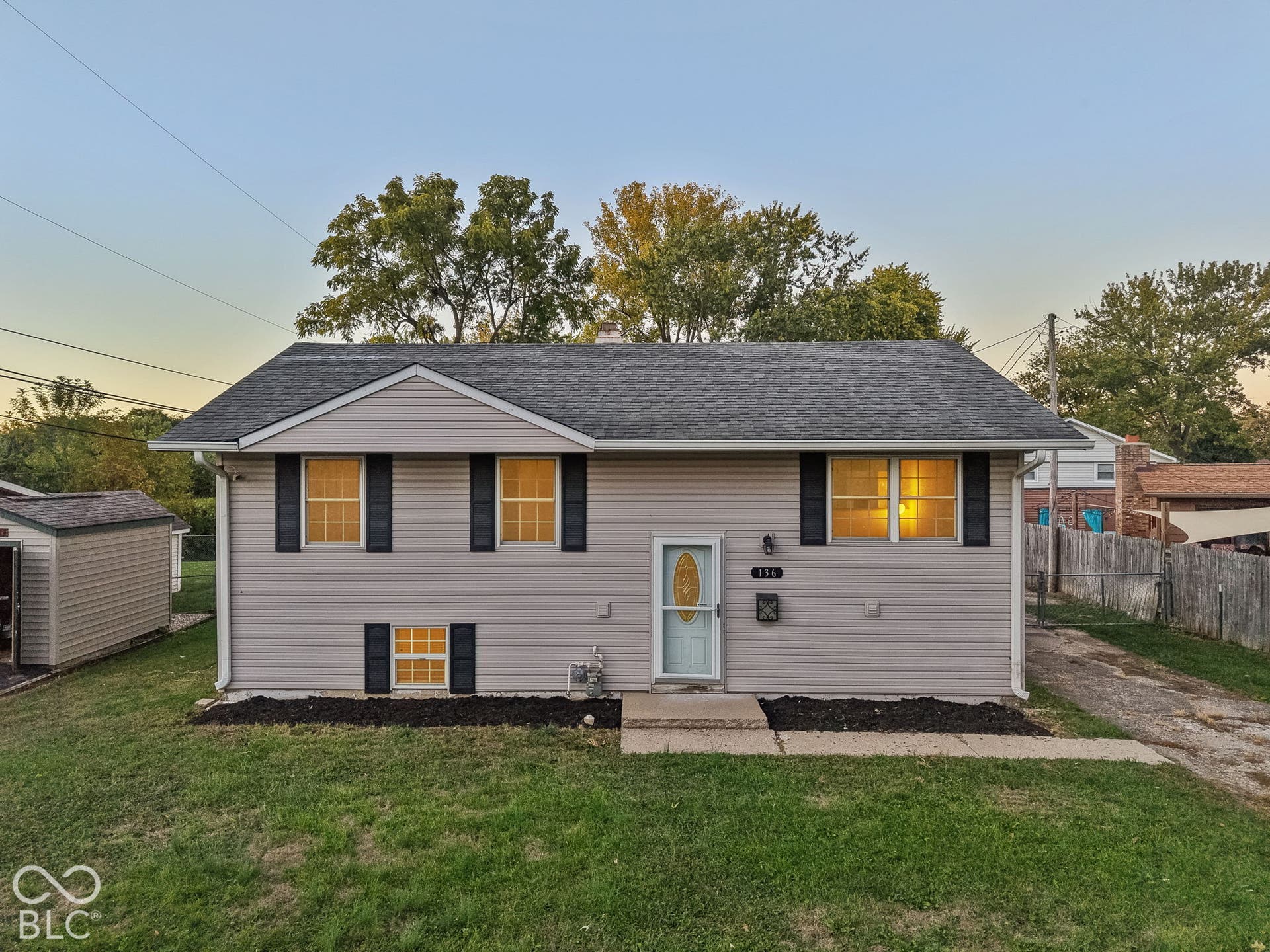 Virtually Altered - Light-colored siding exterior with a dark-shingled roof