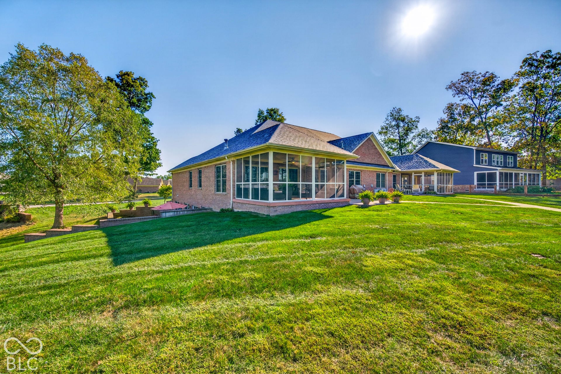 Brick exterior residence featuring a screened-in porch