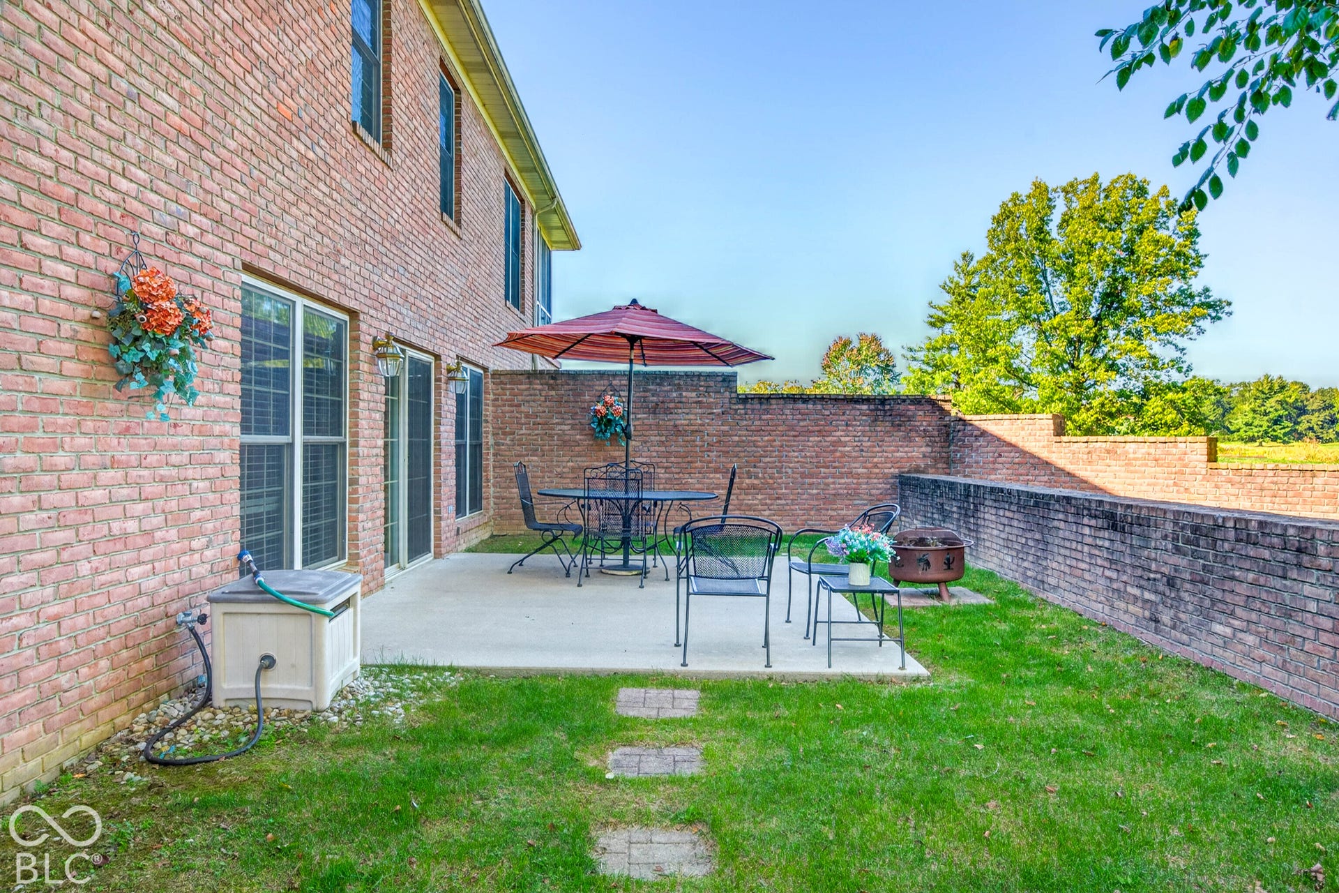 Brick exterior with multiple windows and sliding glass doors