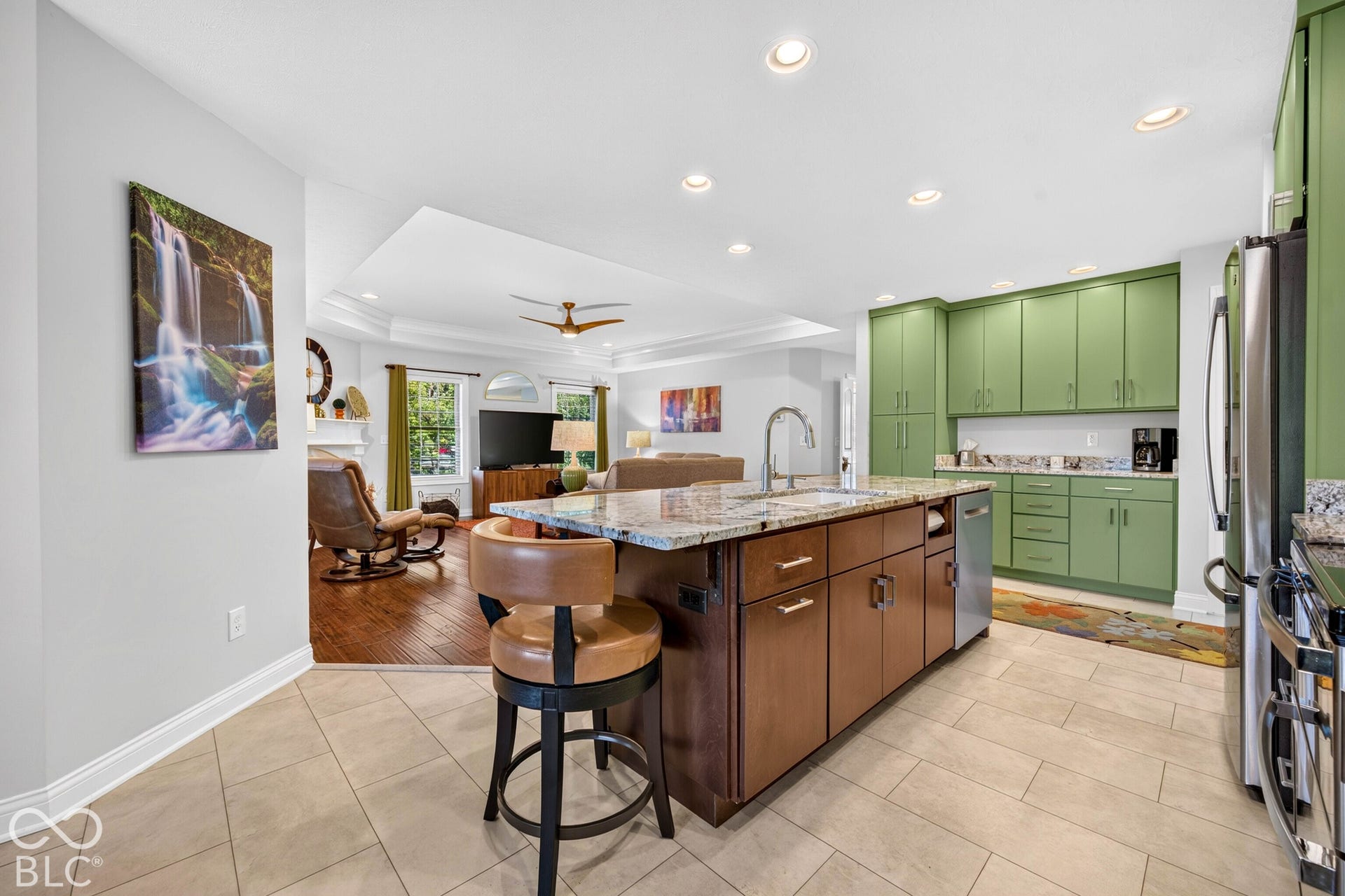 Spacious kitchen island with granite countertop, integrated sink, and dishwasher