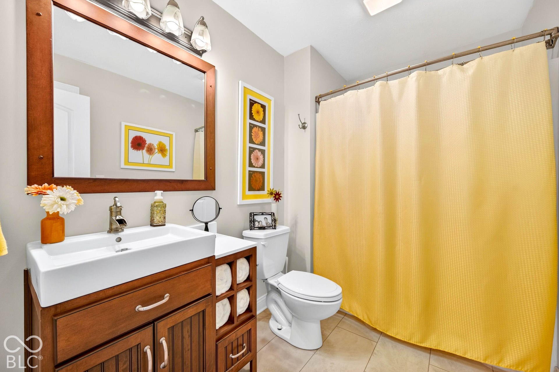 Wood-finish vanity with an integrated rectangular basin and a wall-mounted mirror