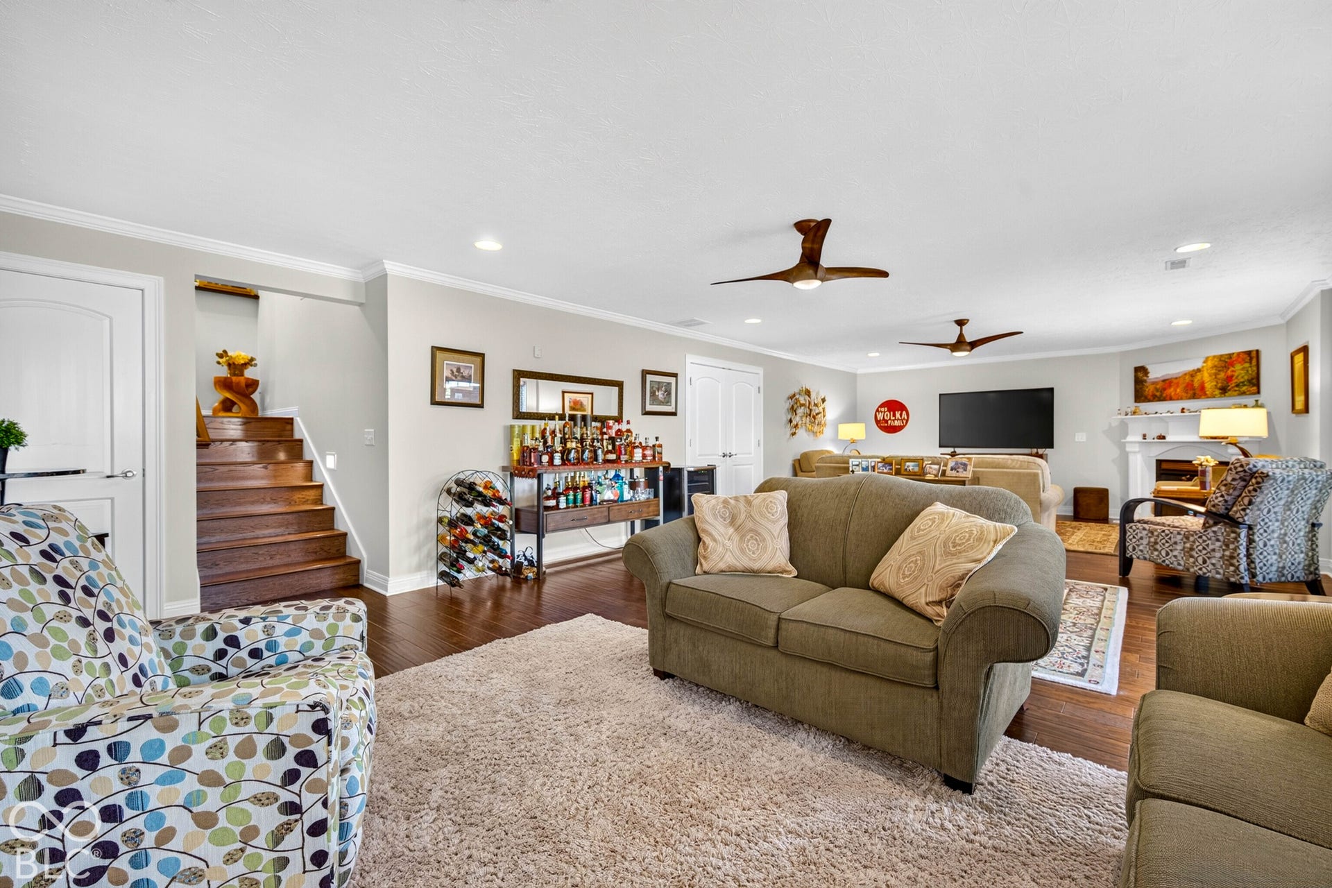 Recessed lighting, wood-finish flooring, white trim, and ceiling fans