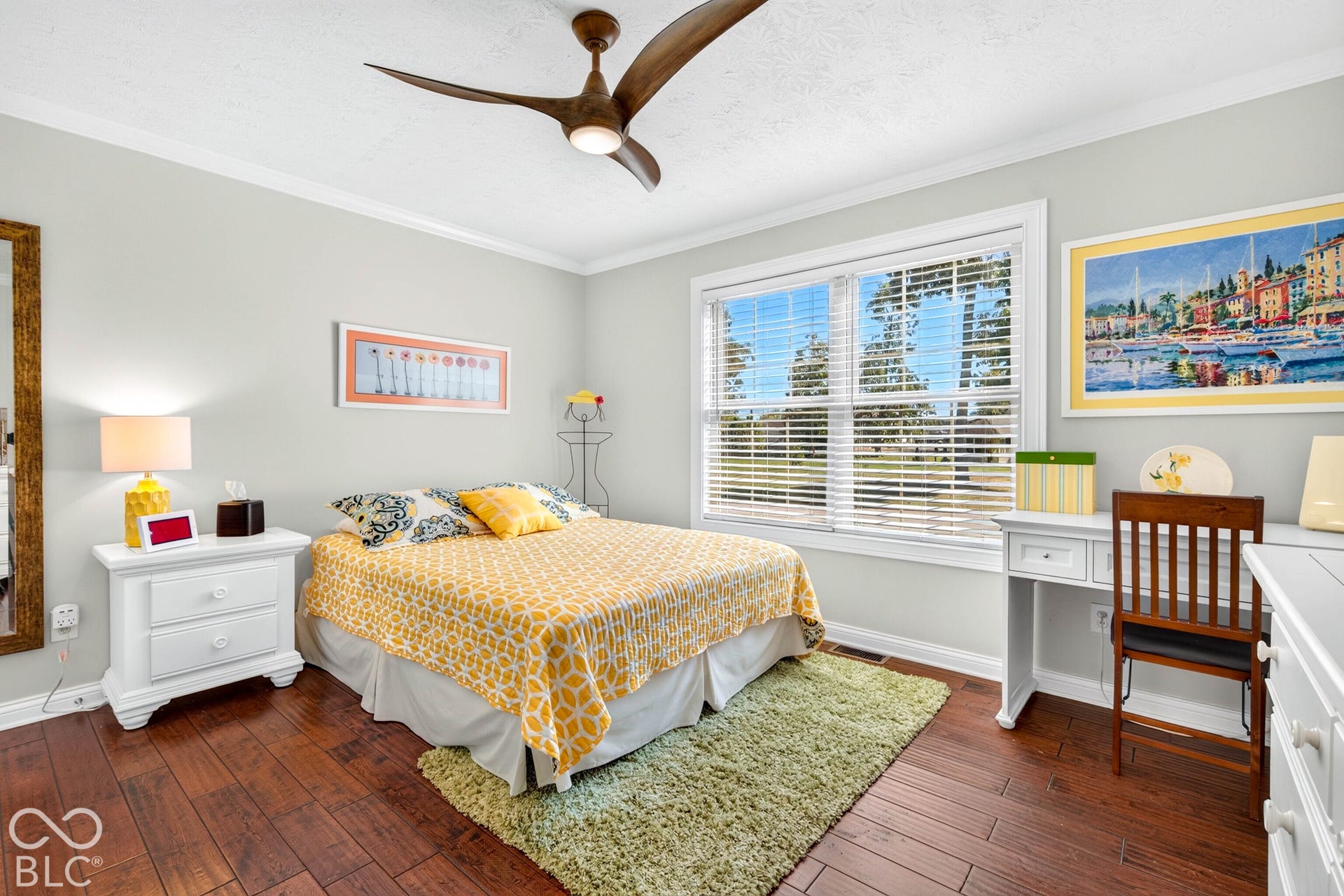 Wood-finish flooring with crown molding and white trim