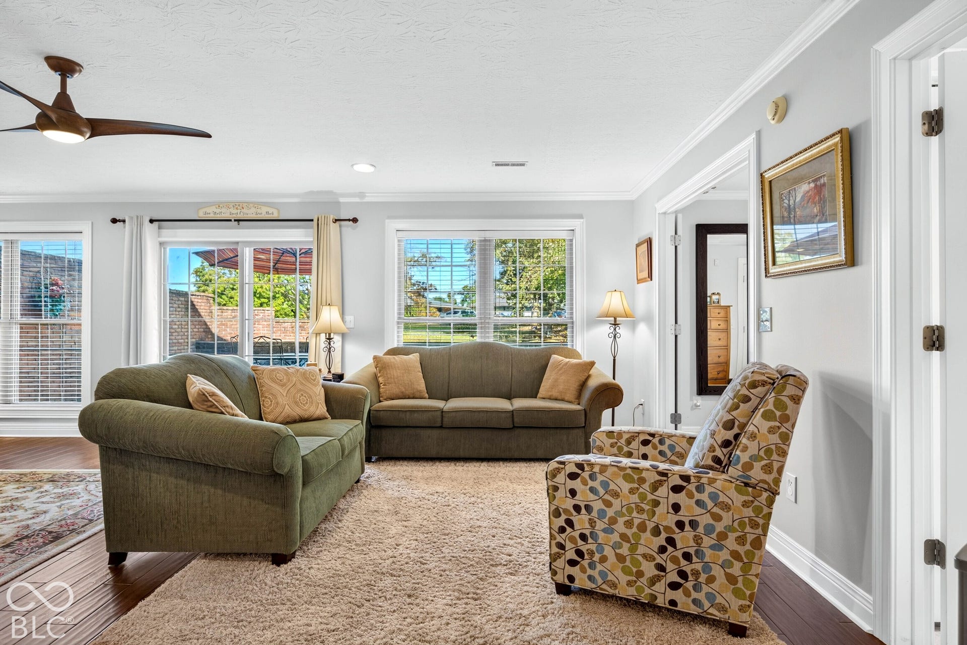 Wood-finish flooring, recessed lighting, and a ceiling fan with integrated lighting