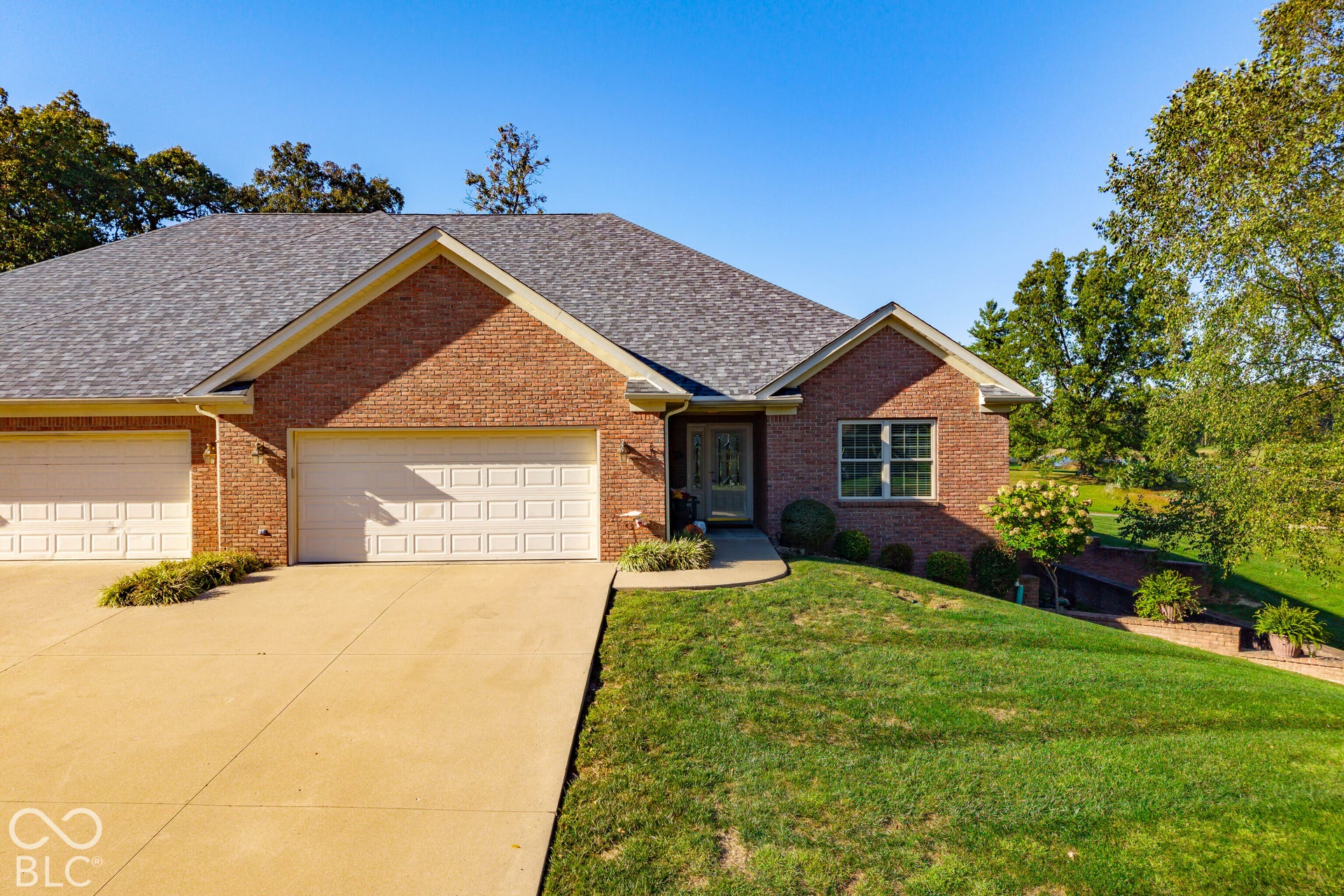 Brick exterior with a gray shingle roof