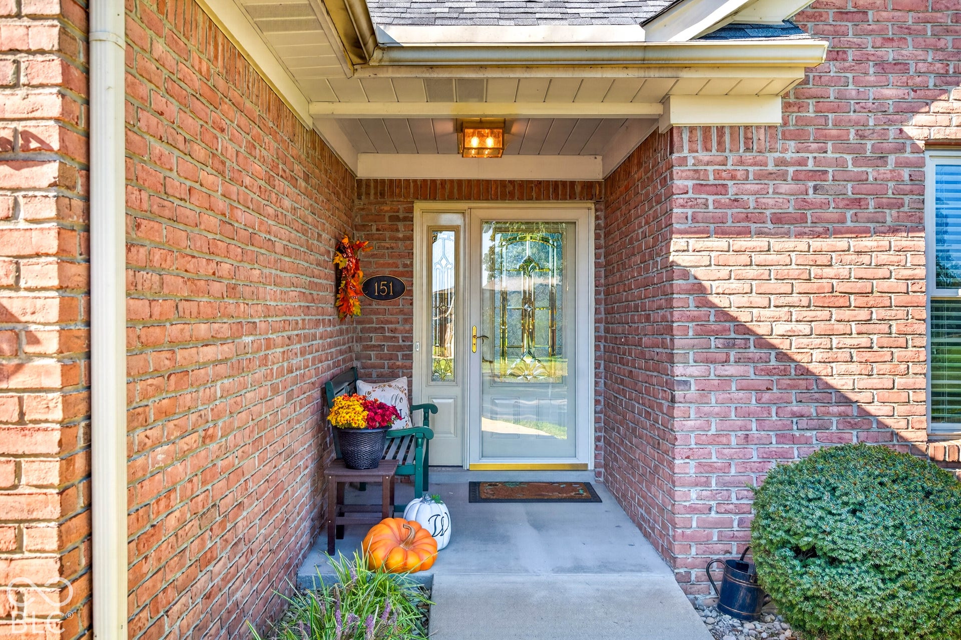 Red brick exterior with a covered entry