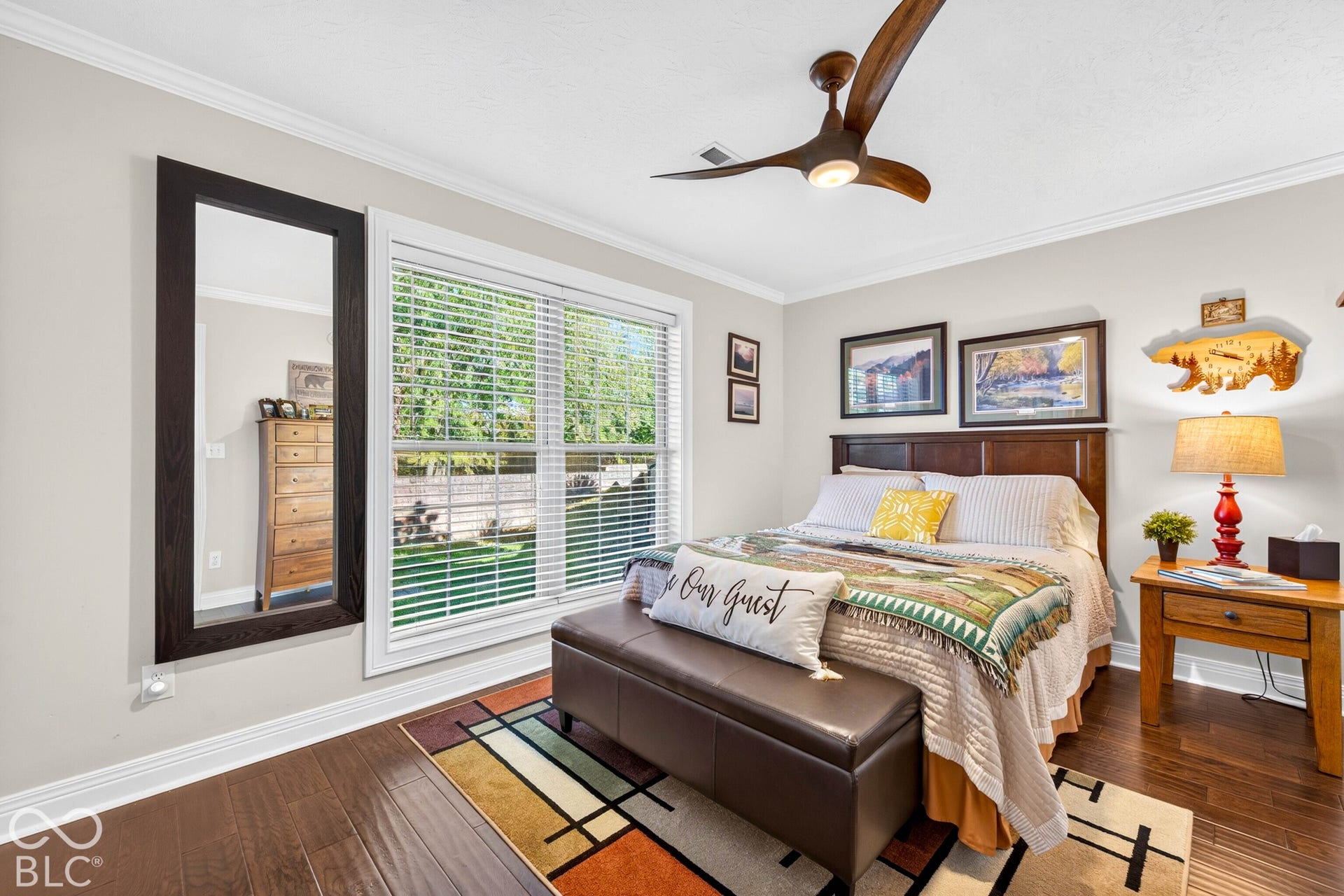 Hardwood-finish flooring, crown molding, and a ceiling fan with integrated lighting