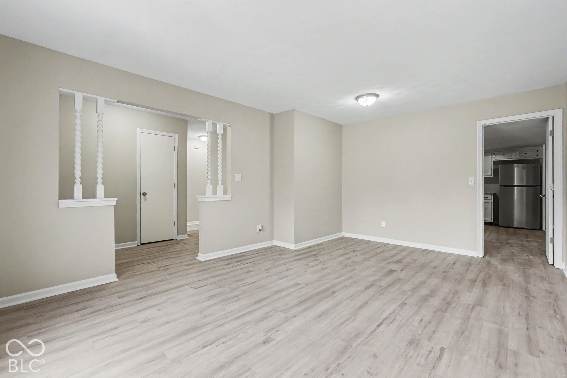 Spacious interior featuring light wood-finish flooring, neutral wall tones, and recessed lighting