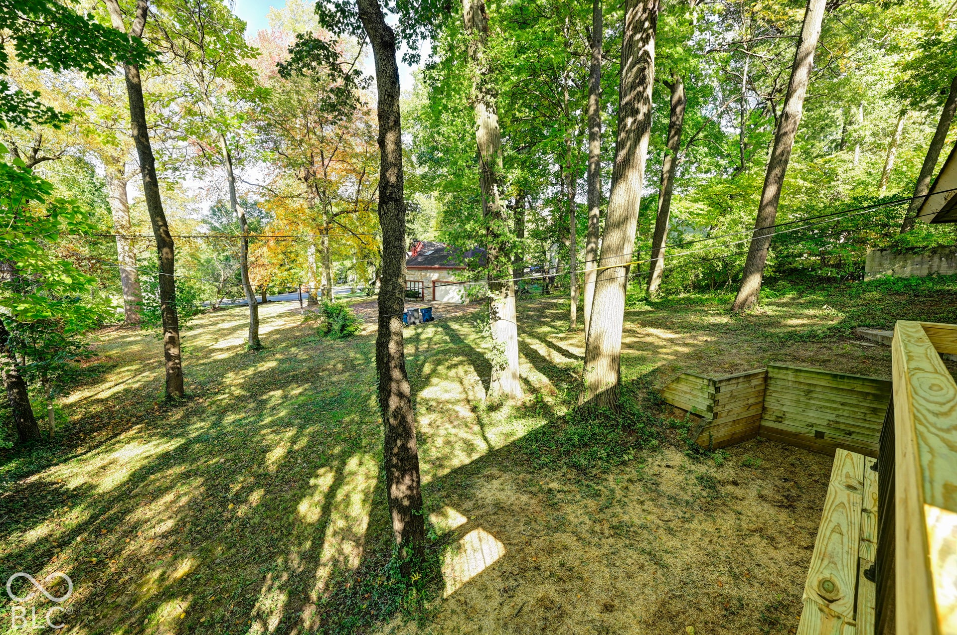 Private wooded ravine lot of about 0.28 acre, with terraced timber walls and mature trees on every side. Rare privacy this close to Butler University and 56th & Illinois.