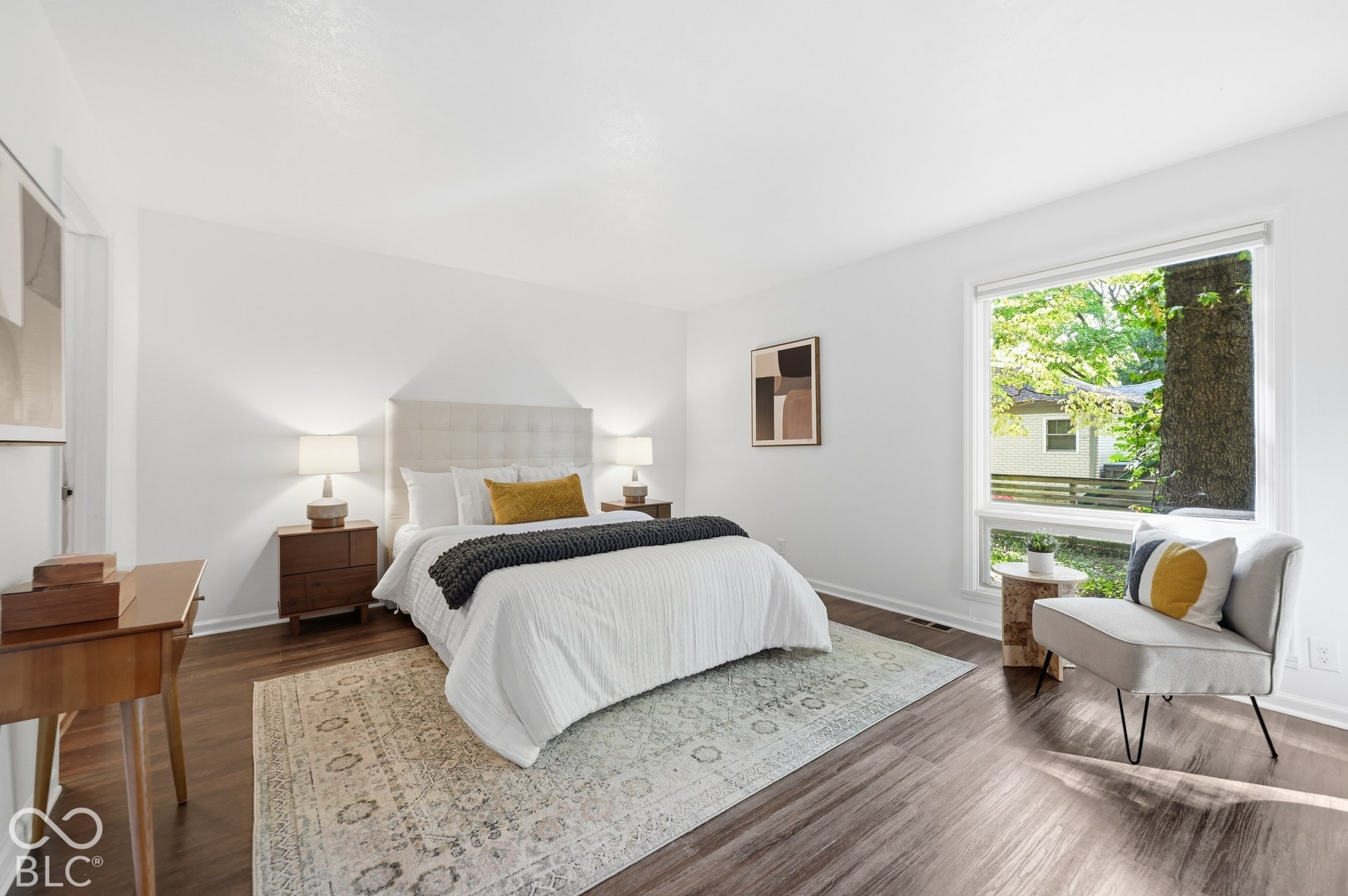 Primary bedroom on the walk-out lower level with a large window into the trees. Quiet, private and sheltered by the hillside.