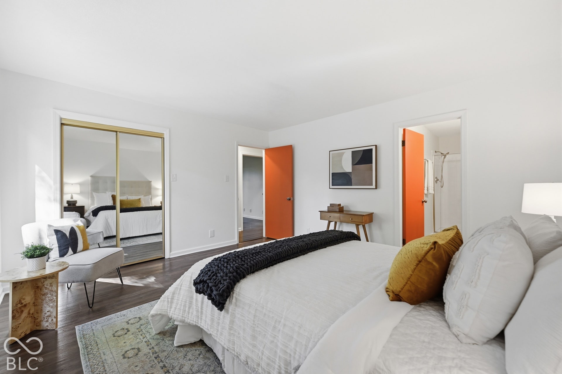 Primary suite with a mirrored walk-in closet and private bath. Every bedroom in the Woods House sits among the trees on the lower level, a rare and deliberate plan.