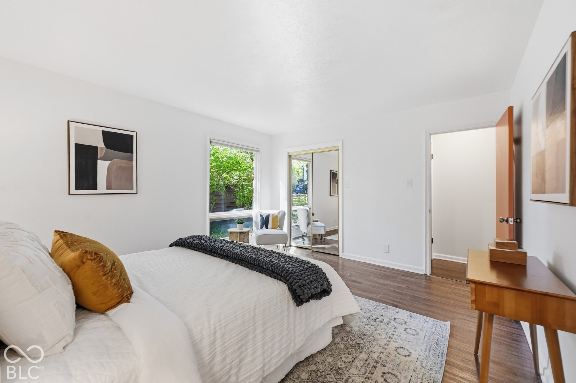 The primary bedroom opens toward its private bath and a view of the yard. A calm retreat a short walk from Butler University.