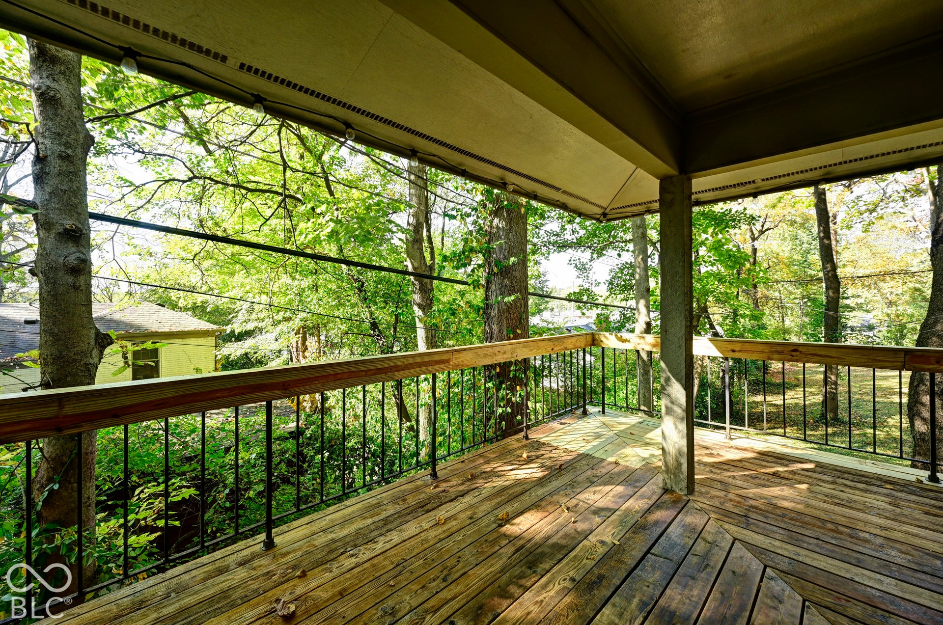 Covered balcony in the treetops, off the dining room. Morning coffee, dinners outside and squirrels close enough to say hello: the treehouse life the Woods family loved for 59 years.