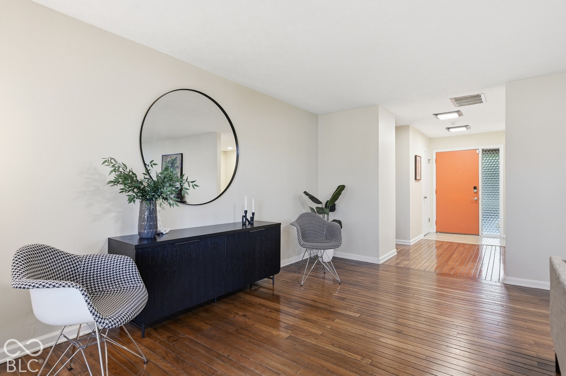 Gallery-worthy walls and long sightlines run from the living room back to the orange front door. Open, light and ready for a midcentury collector's furniture and art.