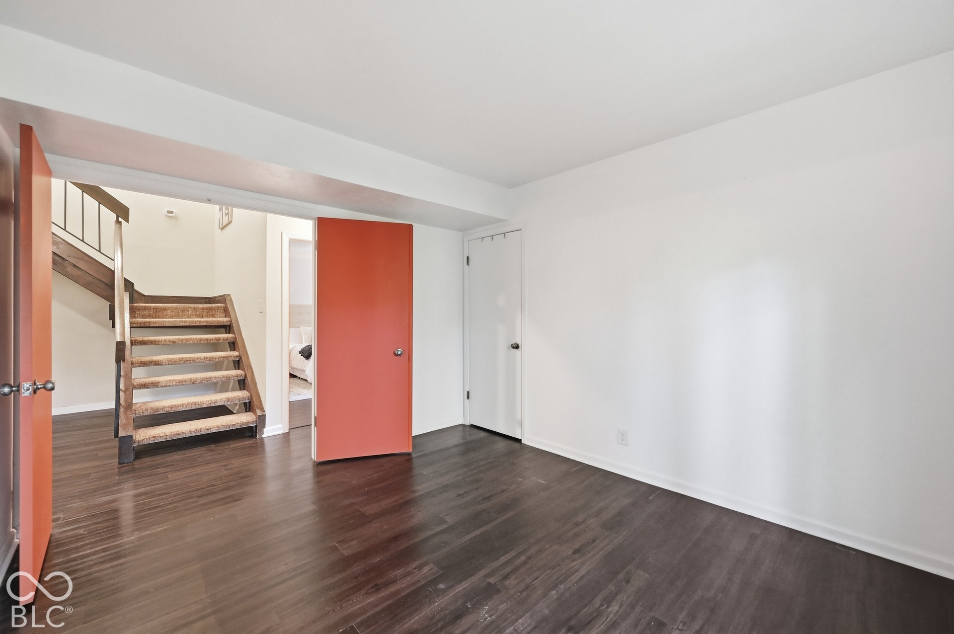 Behind double doors at the foot of the floating staircase, this flexible bedroom also works beautifully as a study or office, with direct access to the yard.