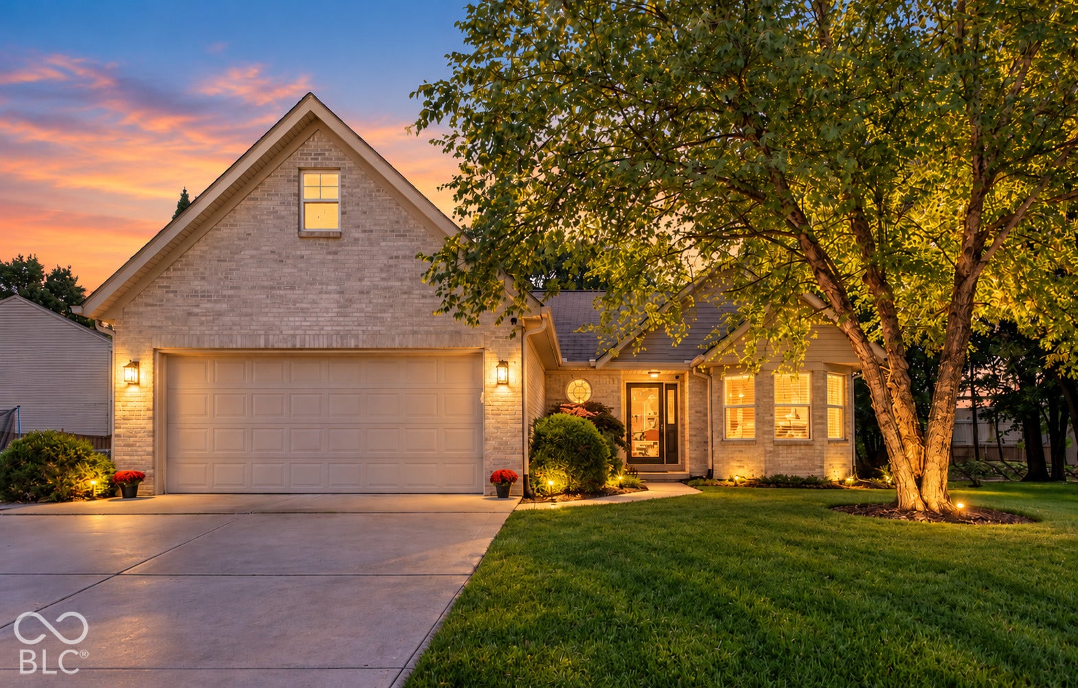 Virtually Altered - Brick exterior with an attached garage, bay windows, and prominent landscaping