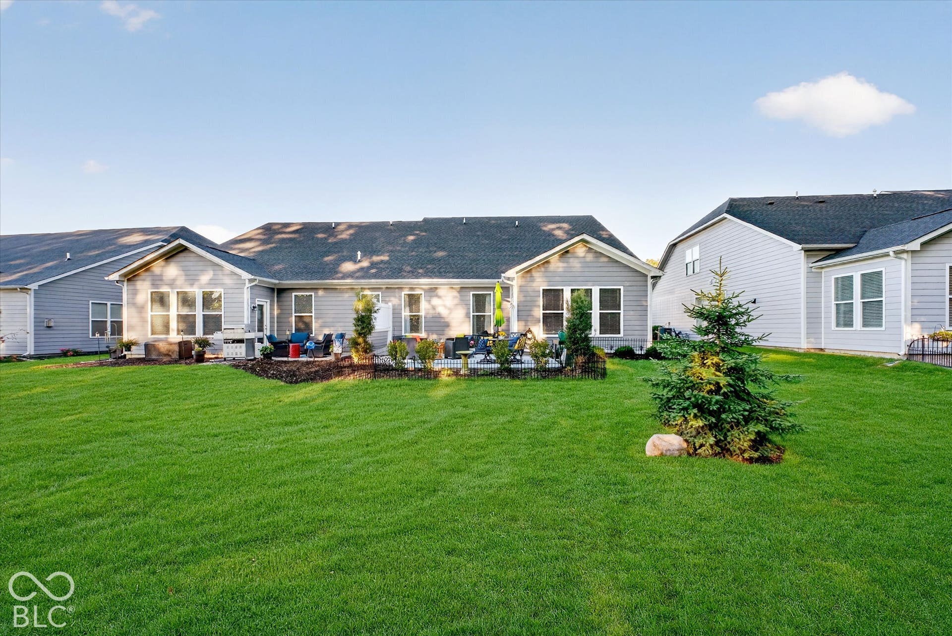 Expansive grassy lawn with established landscaping