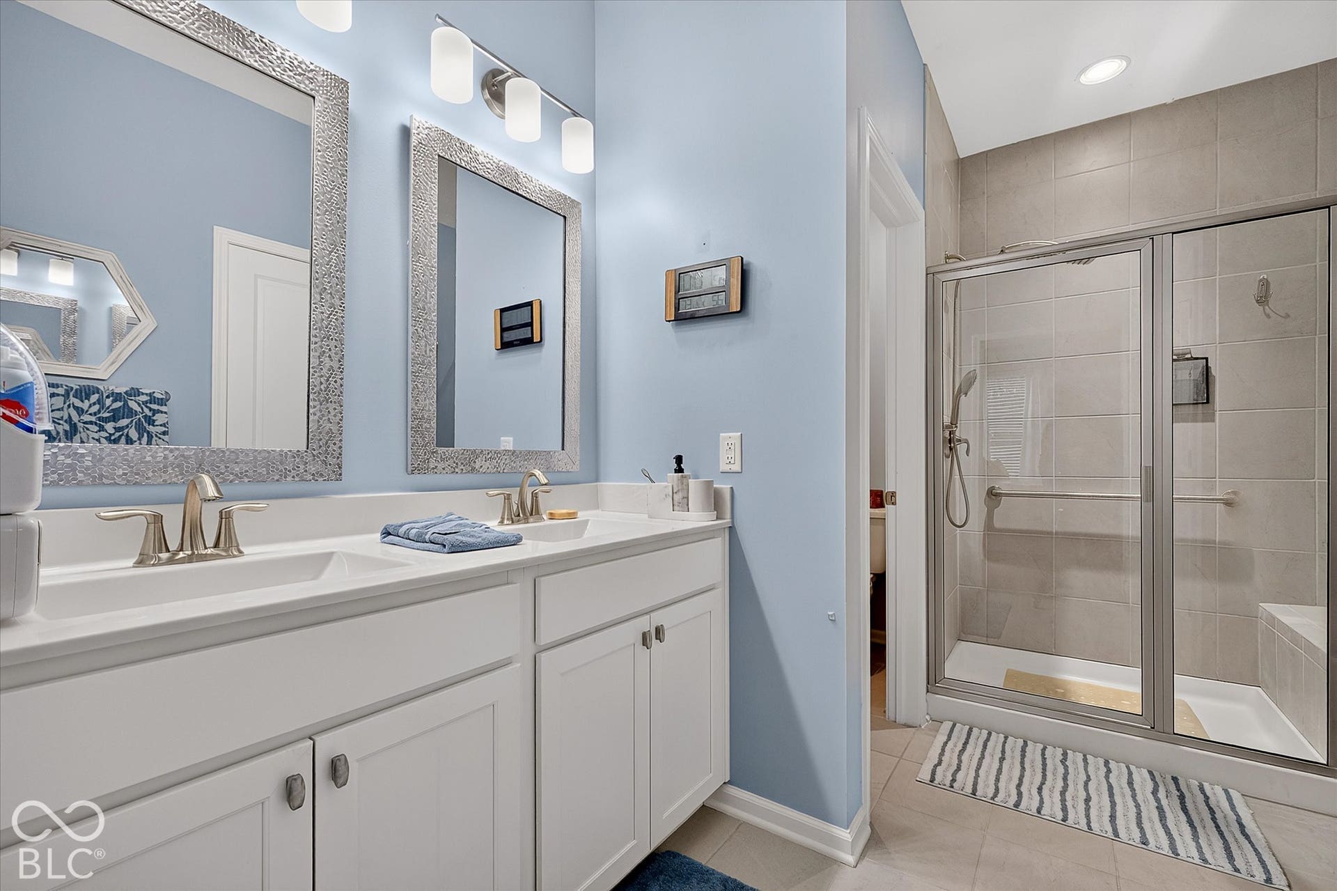 Dual vanity and full shower in the primary bathroom