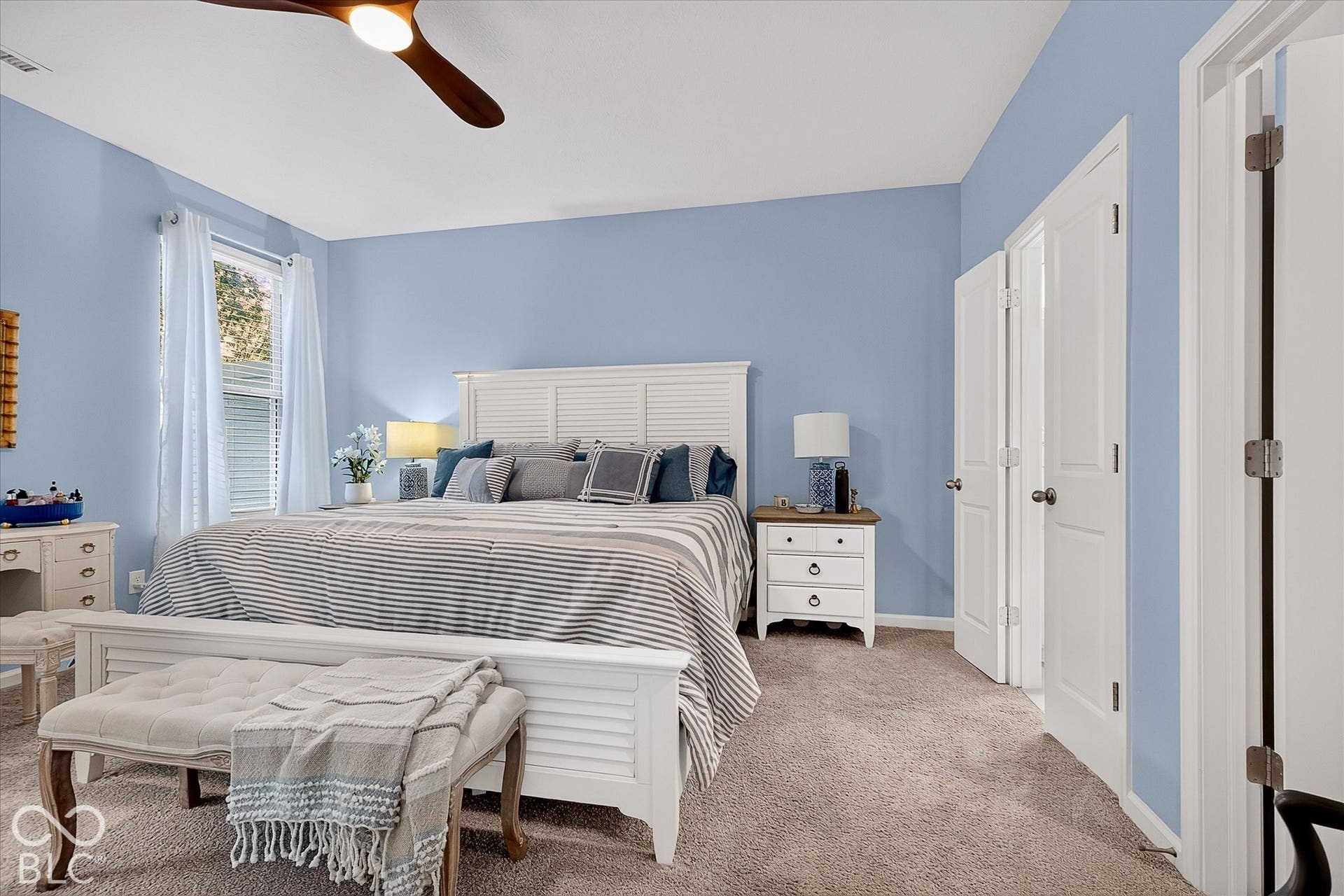 Spacious main level primary bedroom with walk-in closet and bathroom.