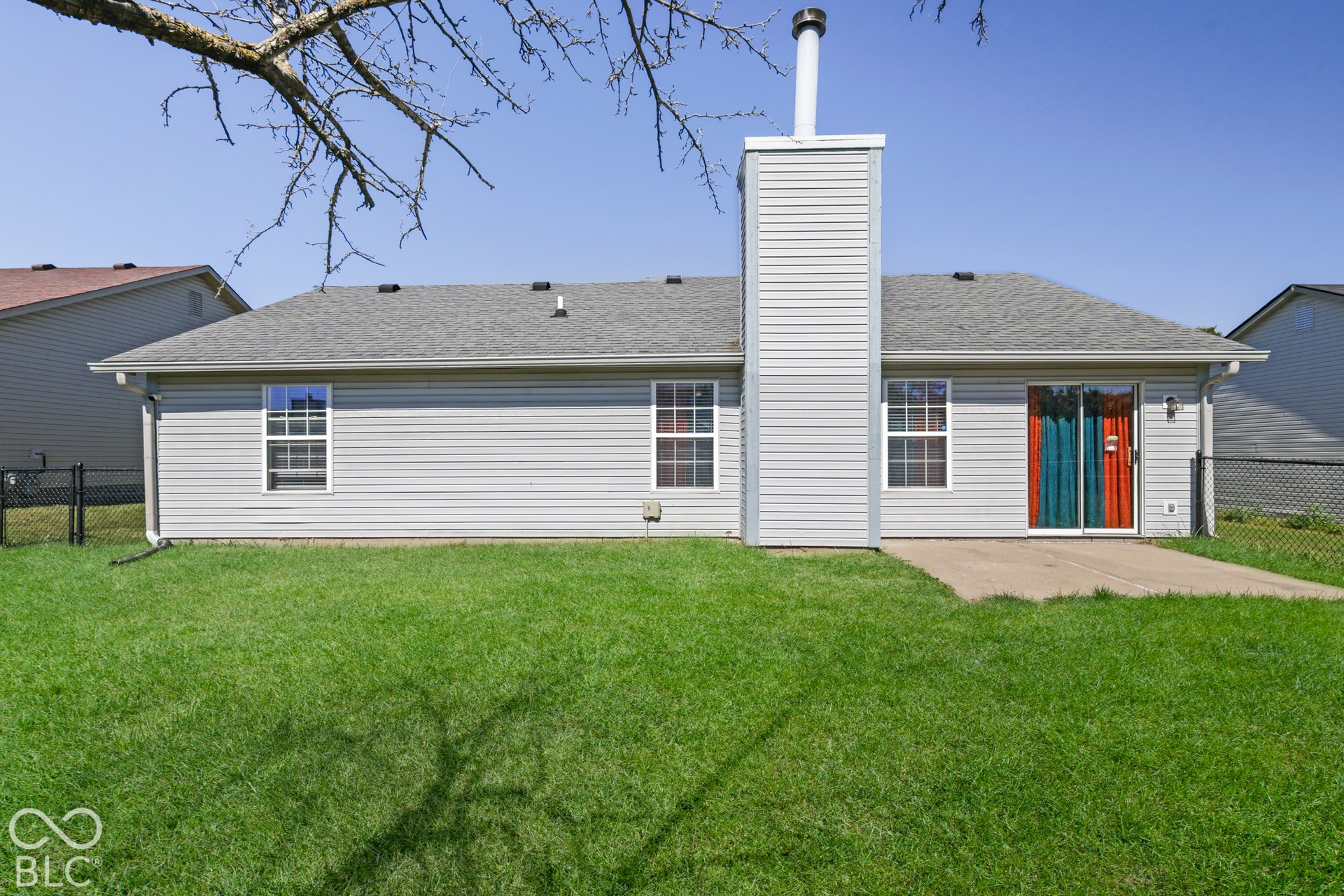 Expansive green lawn with a concrete patio