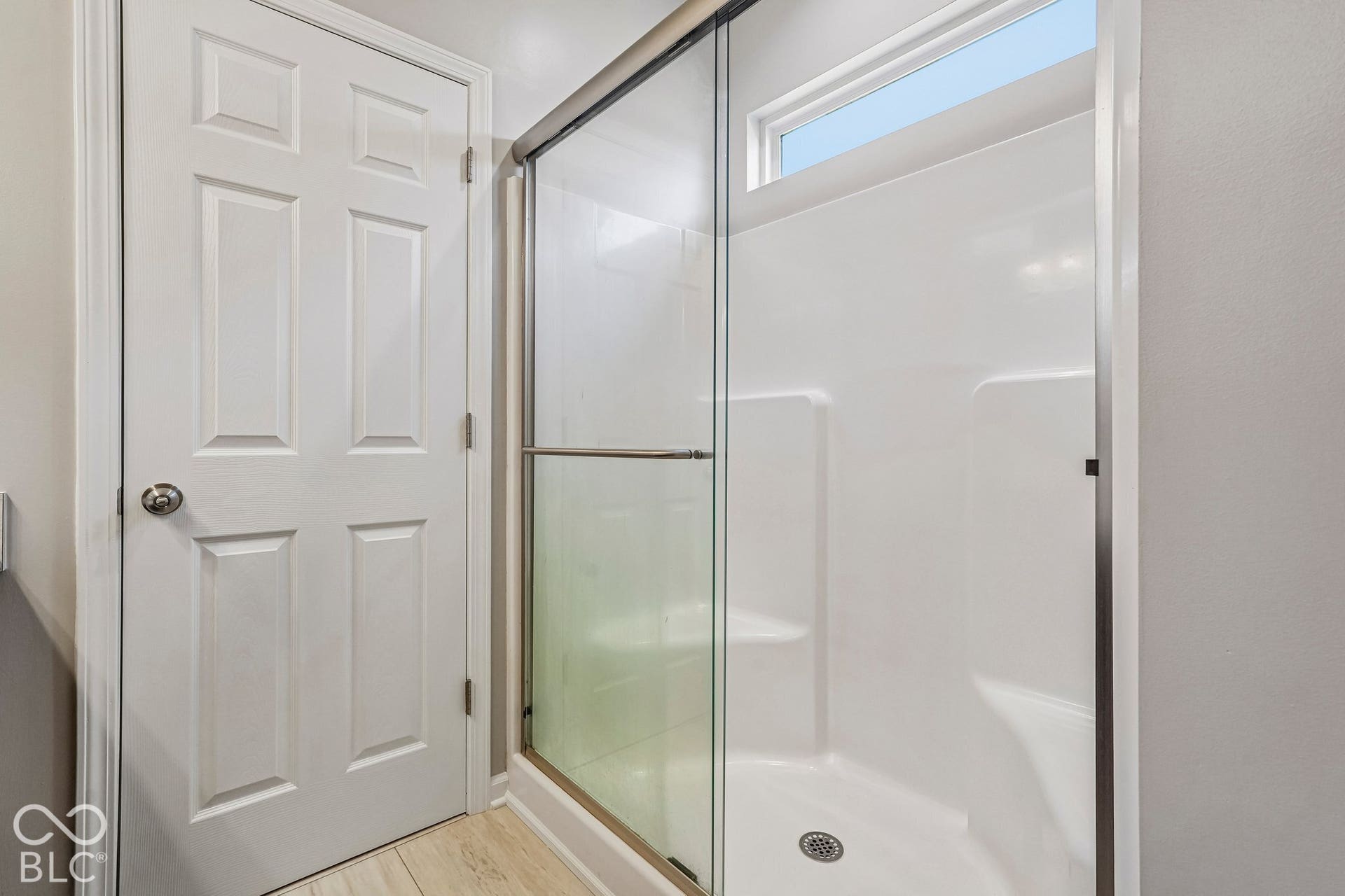 Shower enclosure with glass sliding door and integrated shelving
