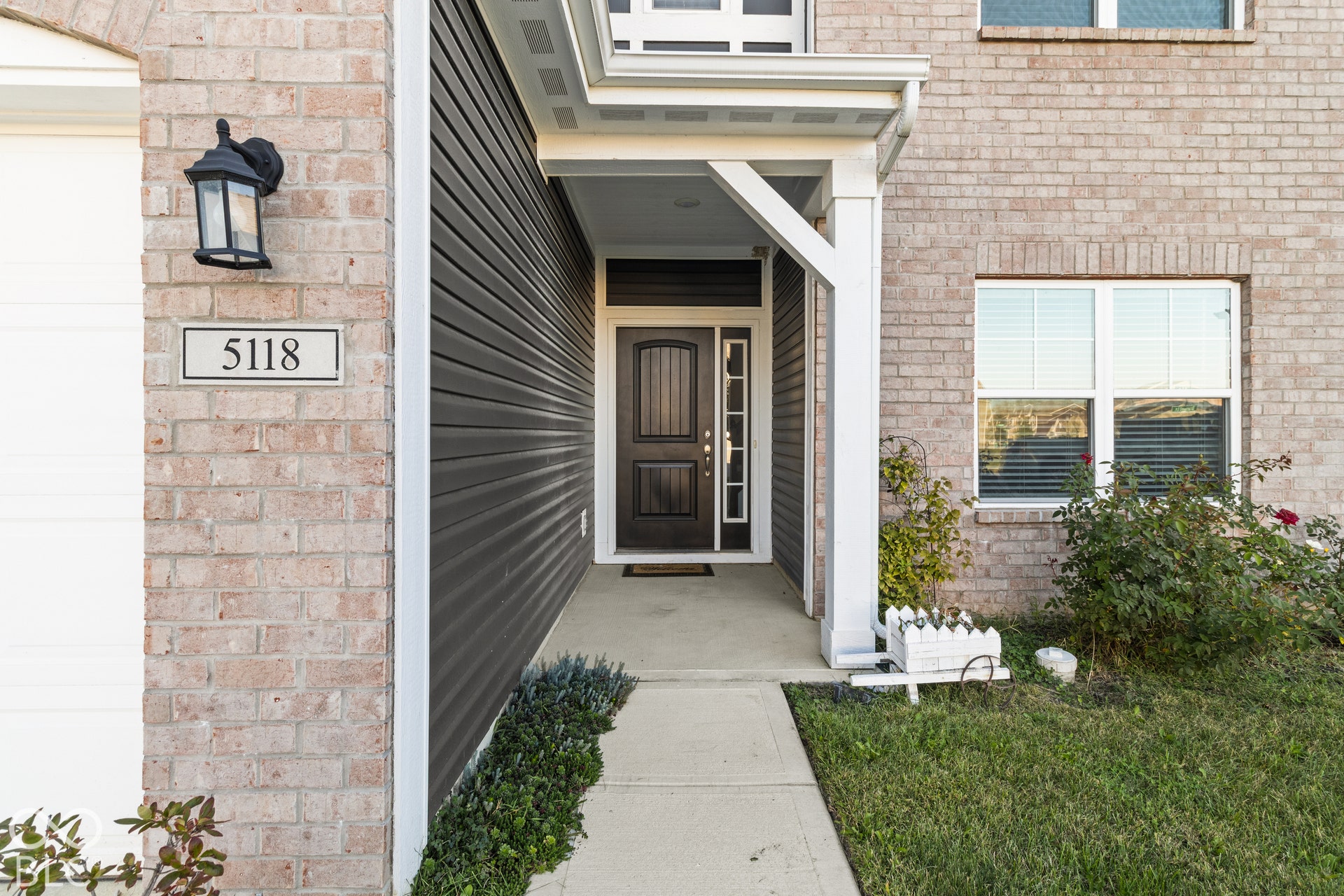 Brick and siding exterior with a covered front entry